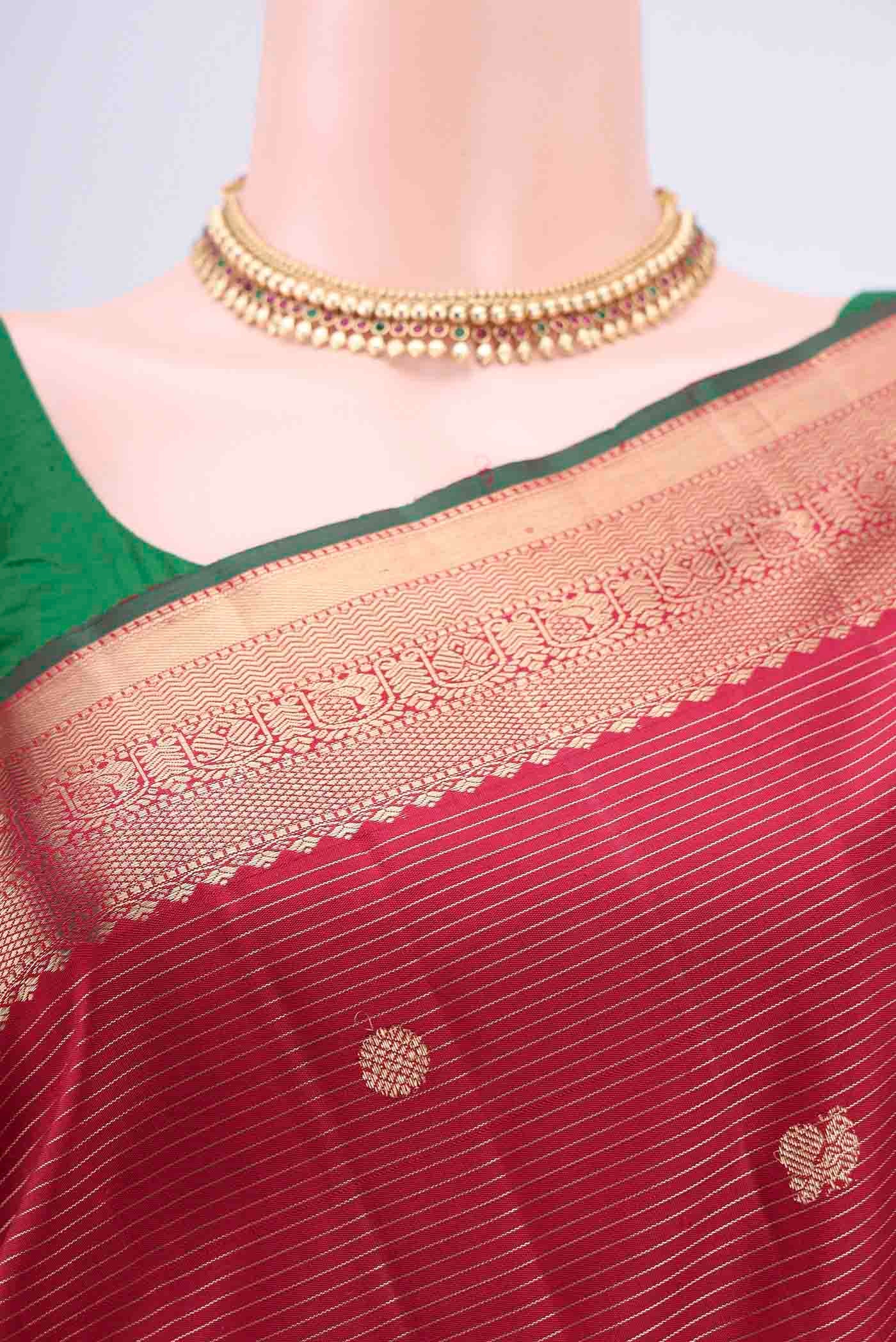 Border image of Maroon Kanjivaram Saree with Zari Butta on the body and Zari Border. 