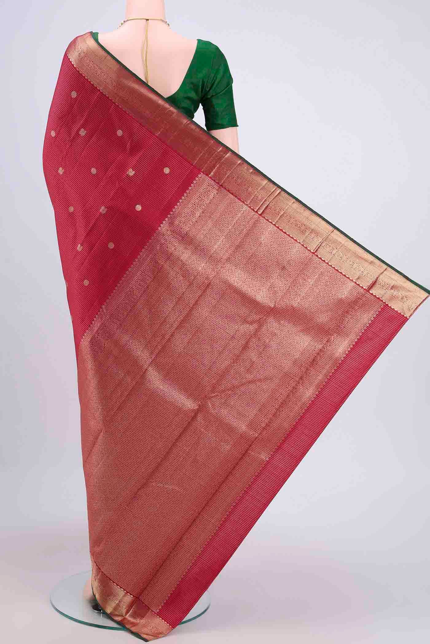 Flat view of Maroon Kanjivaram Saree with Zari Butta on the body and Zari Border. 