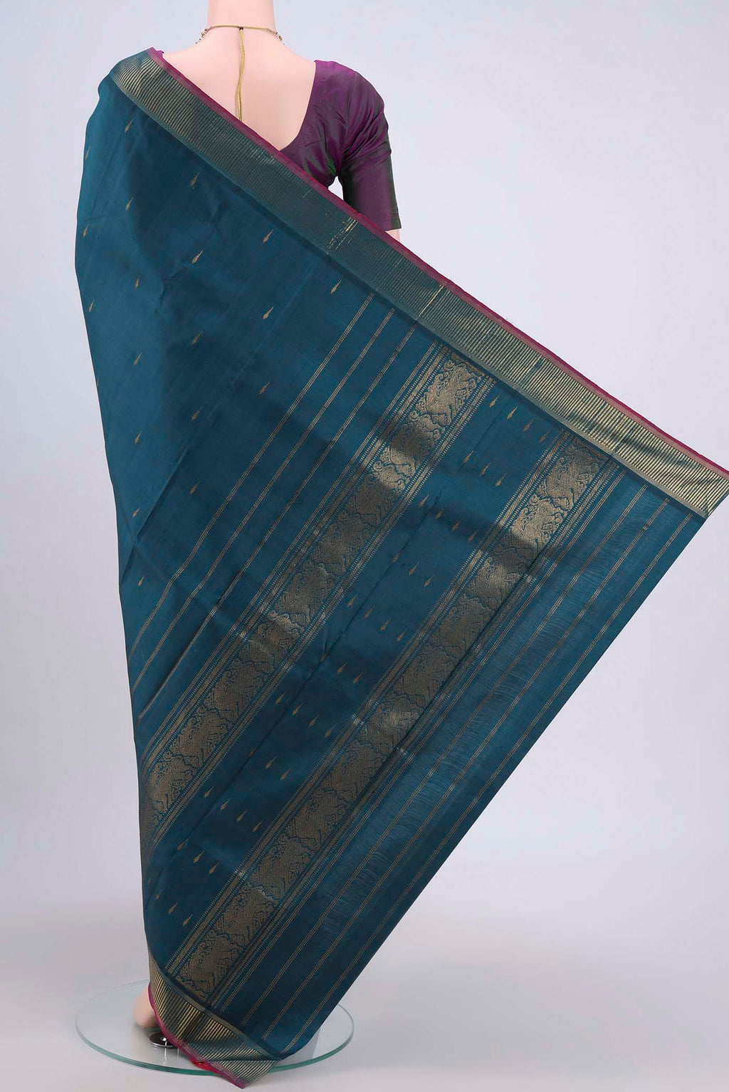 Flat view of Peacock Blue Kanchipuram Saree with Zari Butta on the body and Zari Border. 