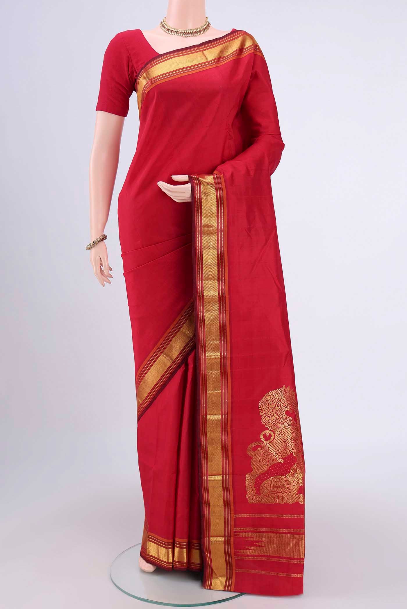 Red Kanchipuram Saree with Plain Body and Zari Border.  displayed on a mannequin