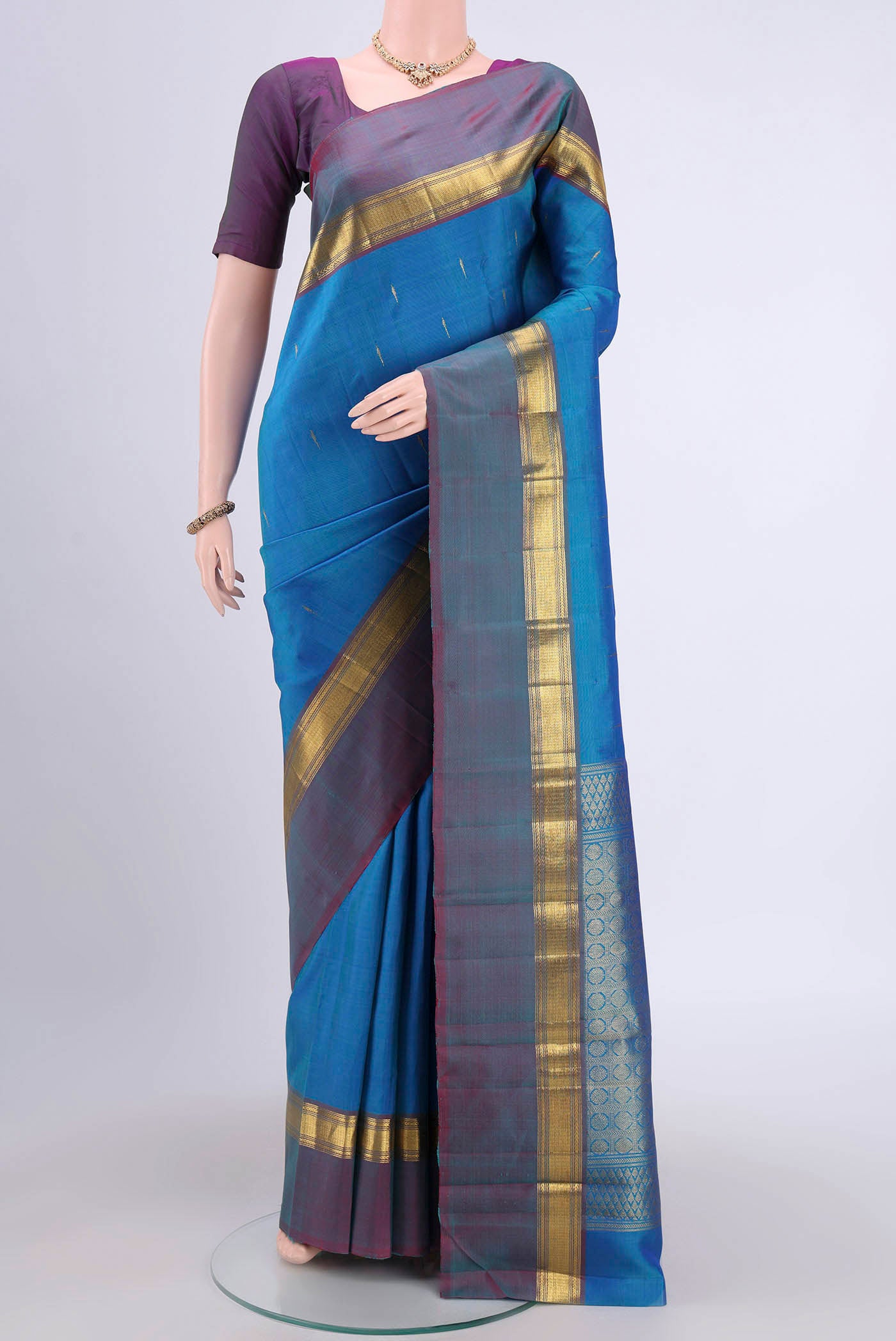 Blue Kanjivaram Saree with Zari Butta on the body and Zari Border.  displayed on a mannequin