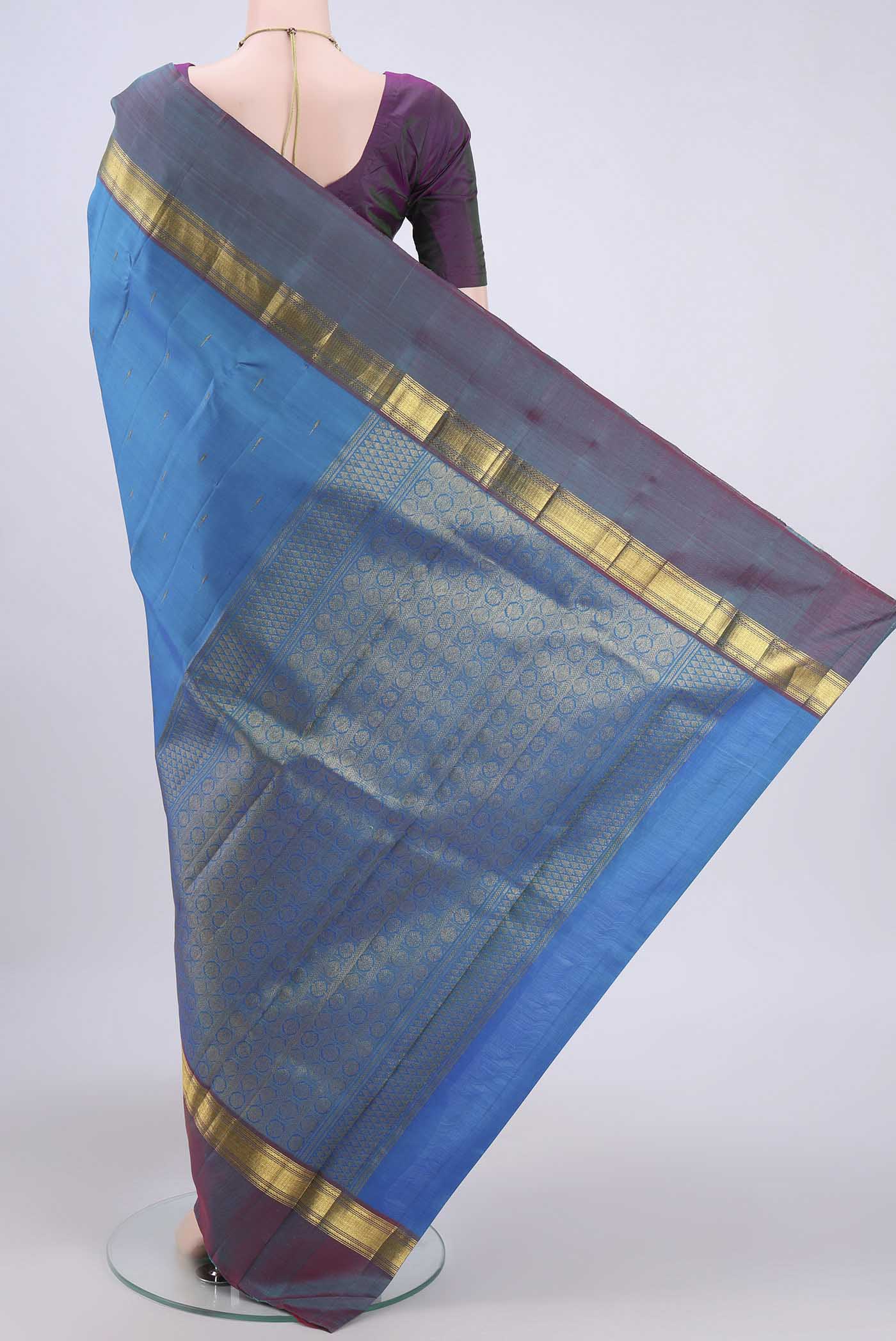 Flat view of Blue Kanjivaram Saree with Zari Butta on the body and Zari Border. 