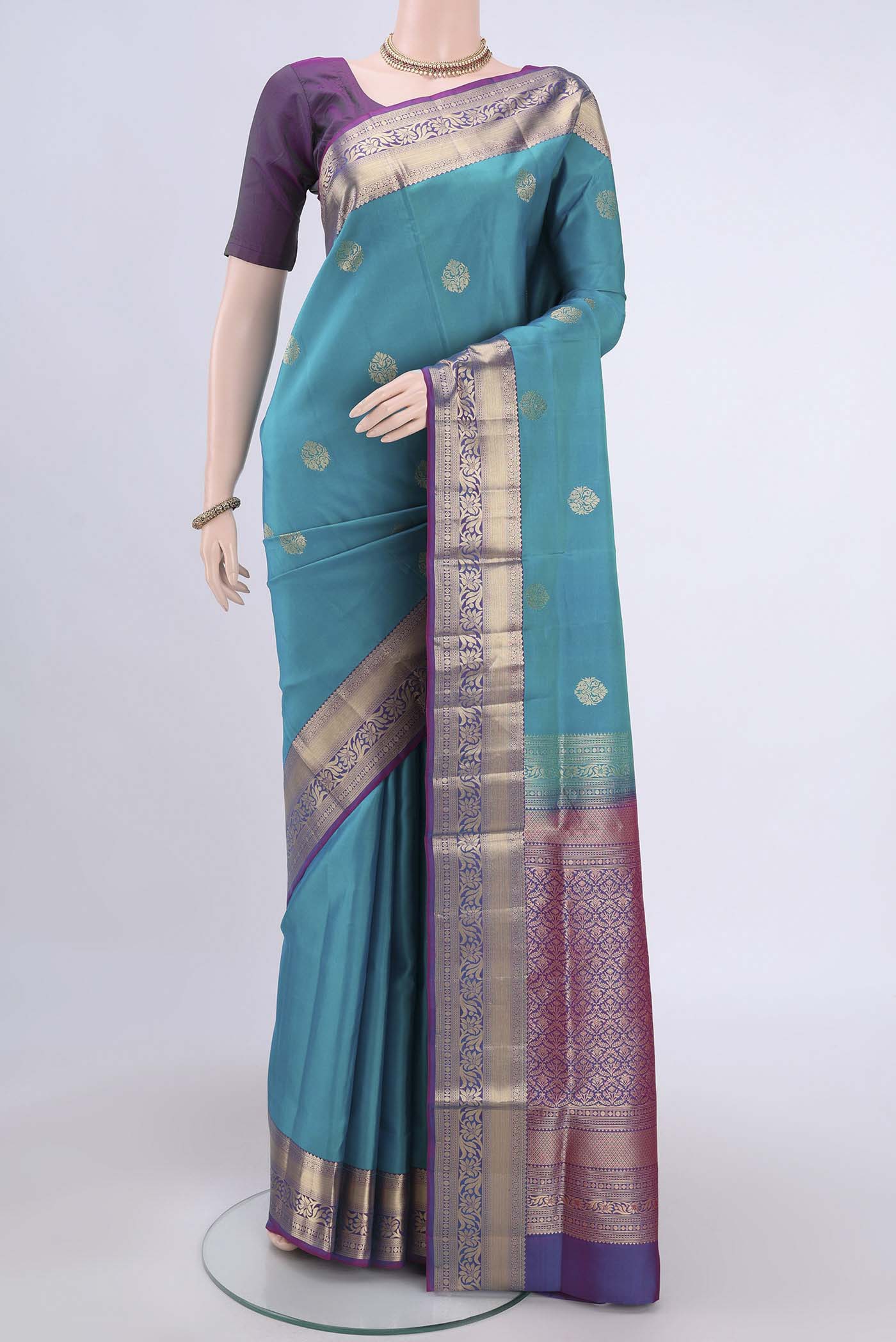 Sea Green Soft Silk Saree with Zari Butta on the body and Zari Border.  displayed on a mannequin
