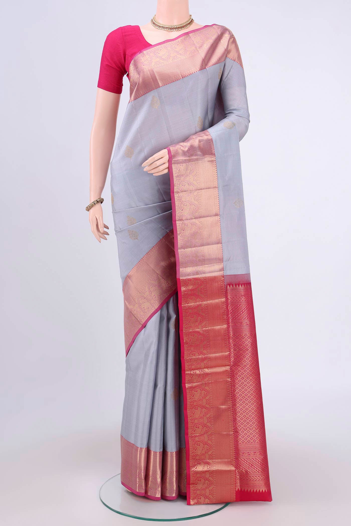 Grey Soft Silk Saree with Zari Butta on the body and Fancy Border.  displayed on a mannequin