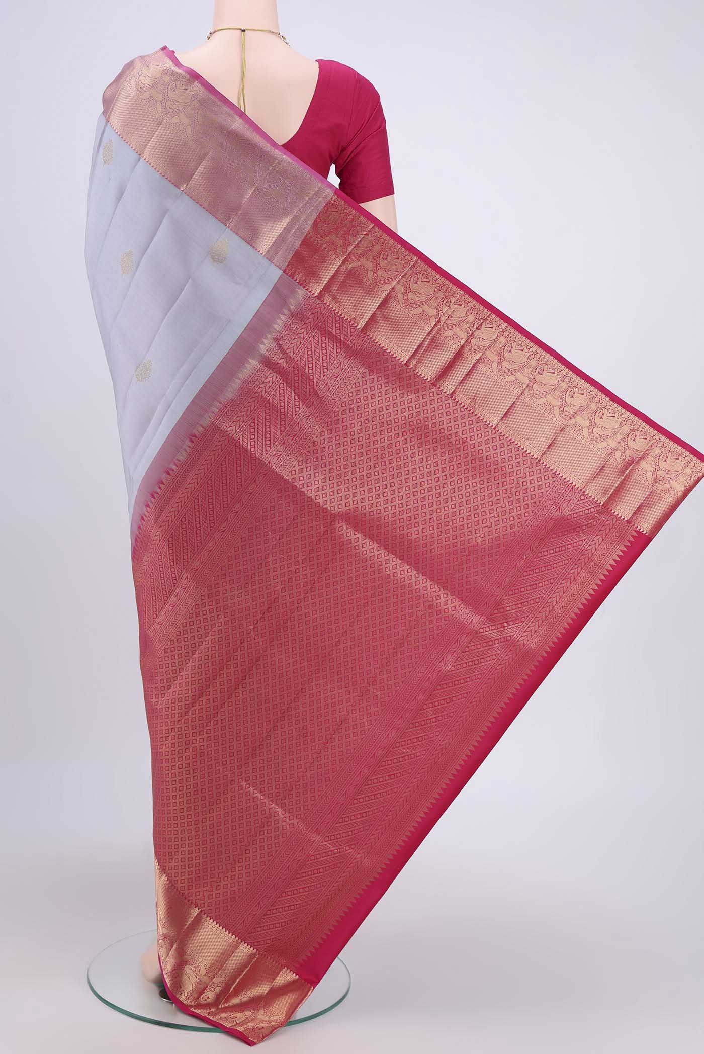 Flat view of Grey Soft Silk Saree with Zari Butta on the body and Fancy Border. 