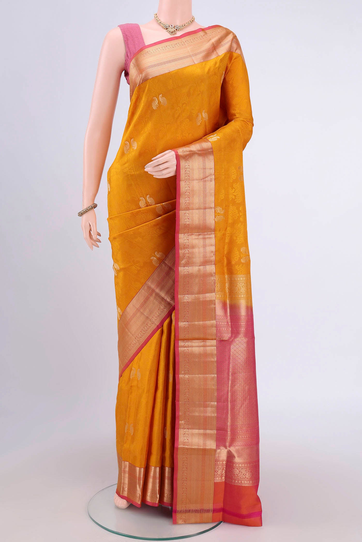 Mustard Soft Silk Saree with Jacquard With Zari Butta on the body and Zari Border.  displayed on a mannequin