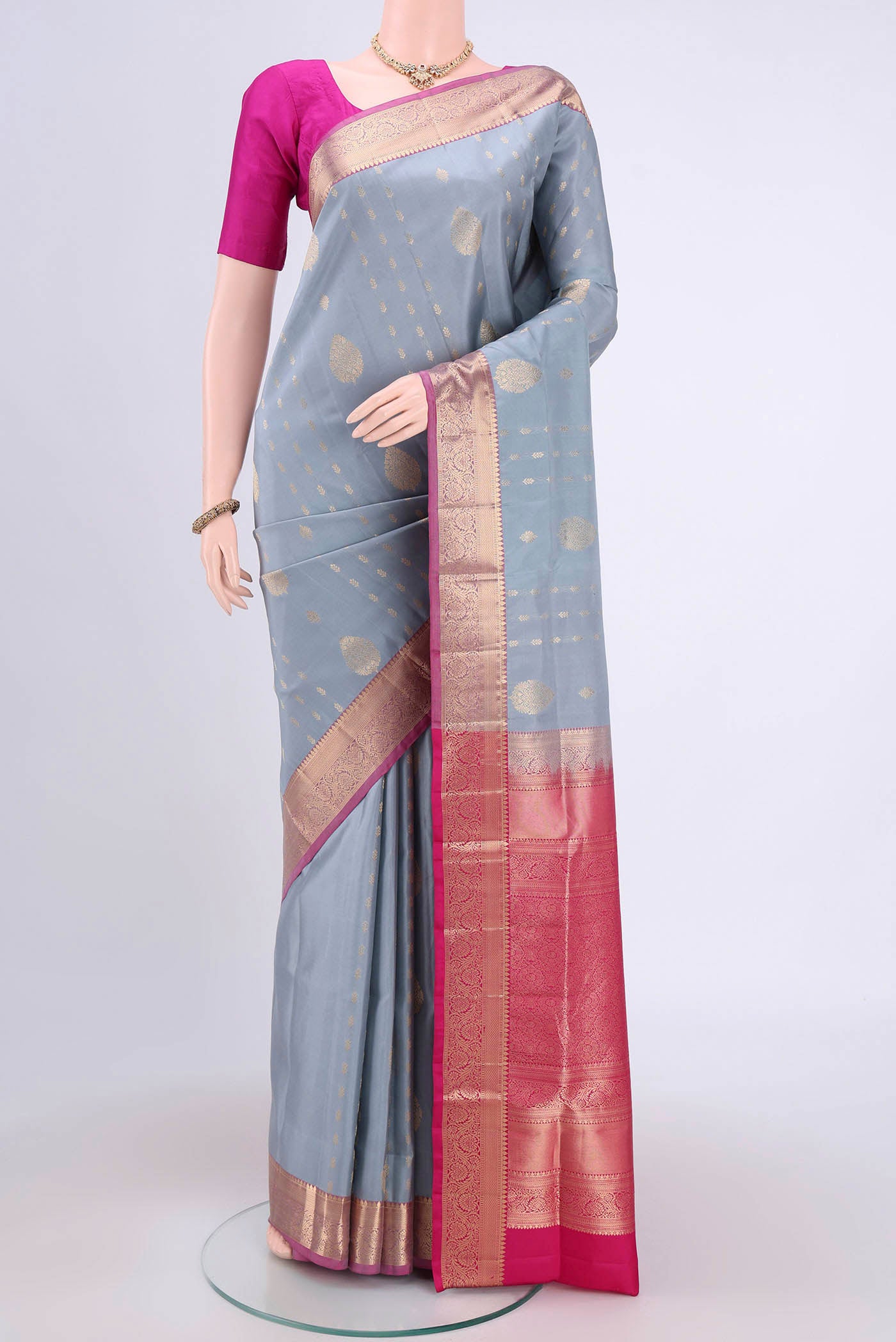 Grey Soft Silk Saree with Zari Butta on the body and Zari Border.  displayed on a mannequin