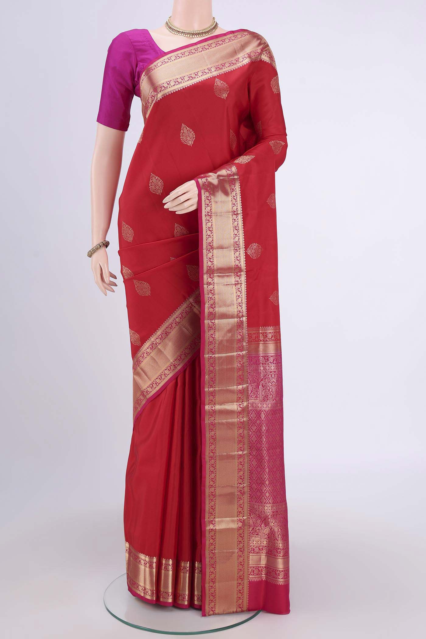 Red Soft Silk Saree with Zari Butta on the body and Fancy Border.  displayed on a mannequin