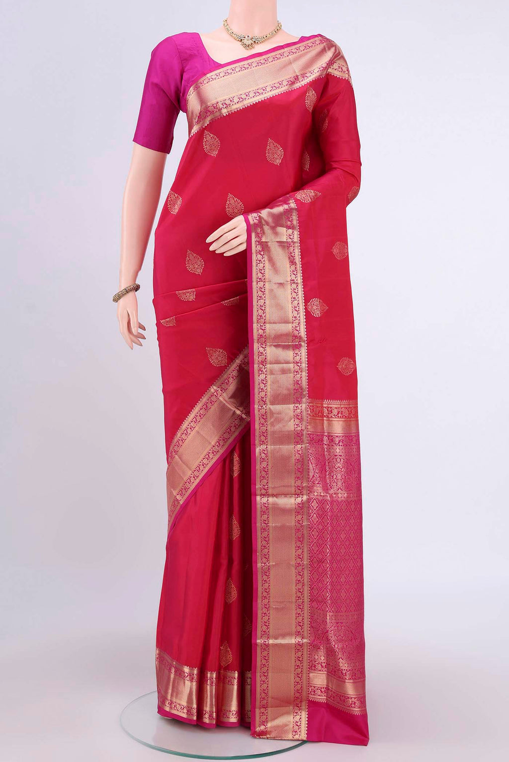 Dark Pink Soft Silk Saree with Zari Butta on the body and Zari Border.  displayed on a mannequin