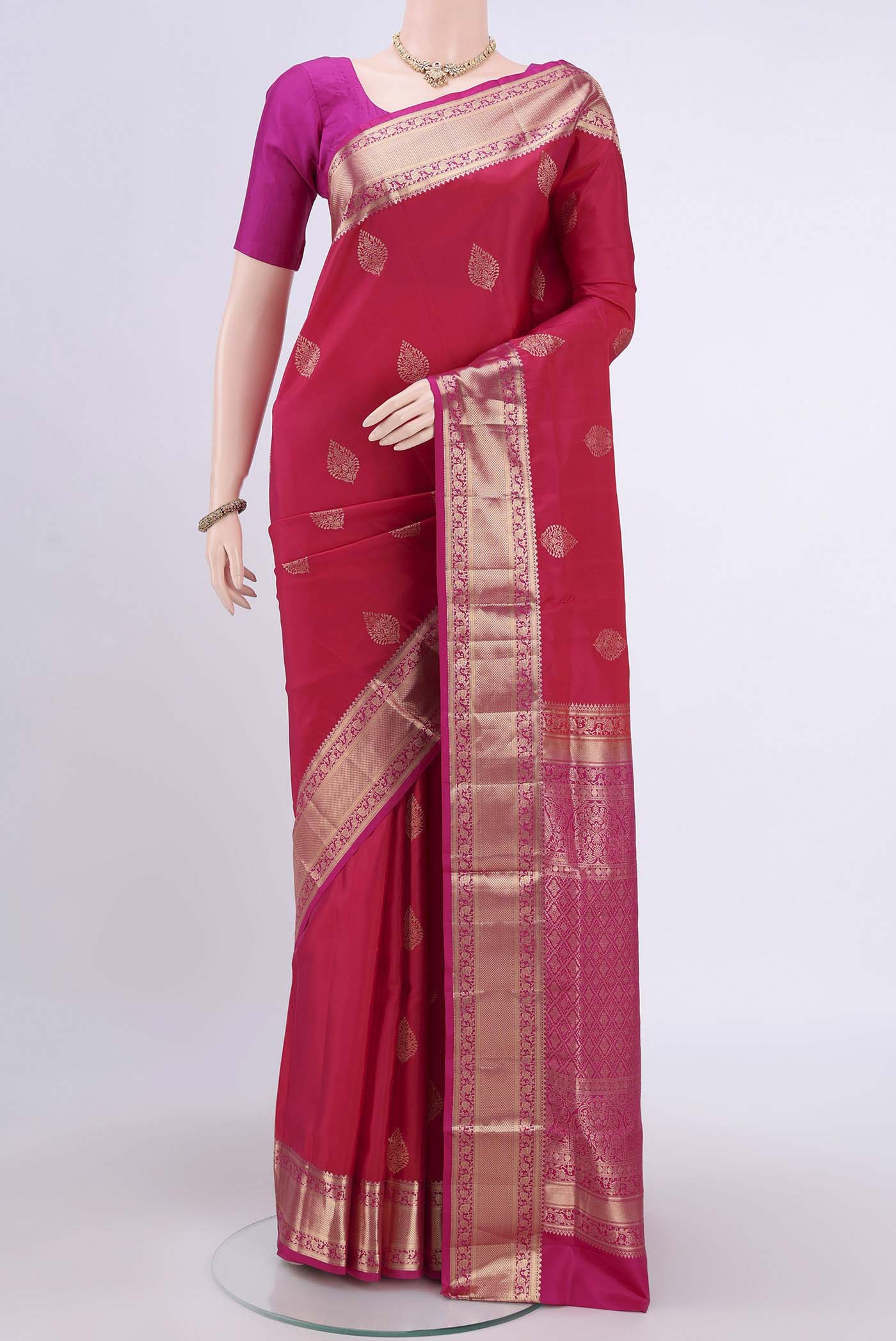Dark Pink Soft Silk Saree with Zari Butta on the body and Zari Border.  displayed on a mannequin