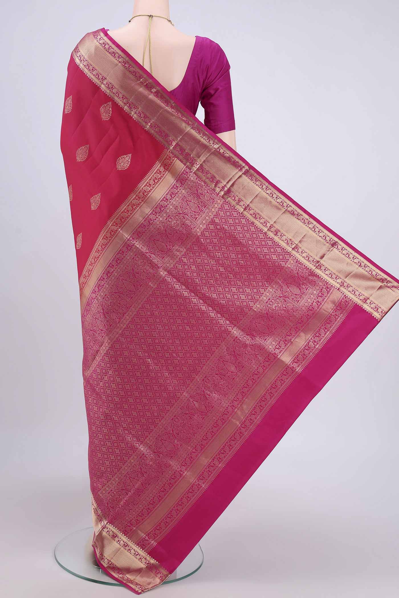 Flat view of Dark Pink Soft Silk Saree with Zari Butta on the body and Zari Border. 