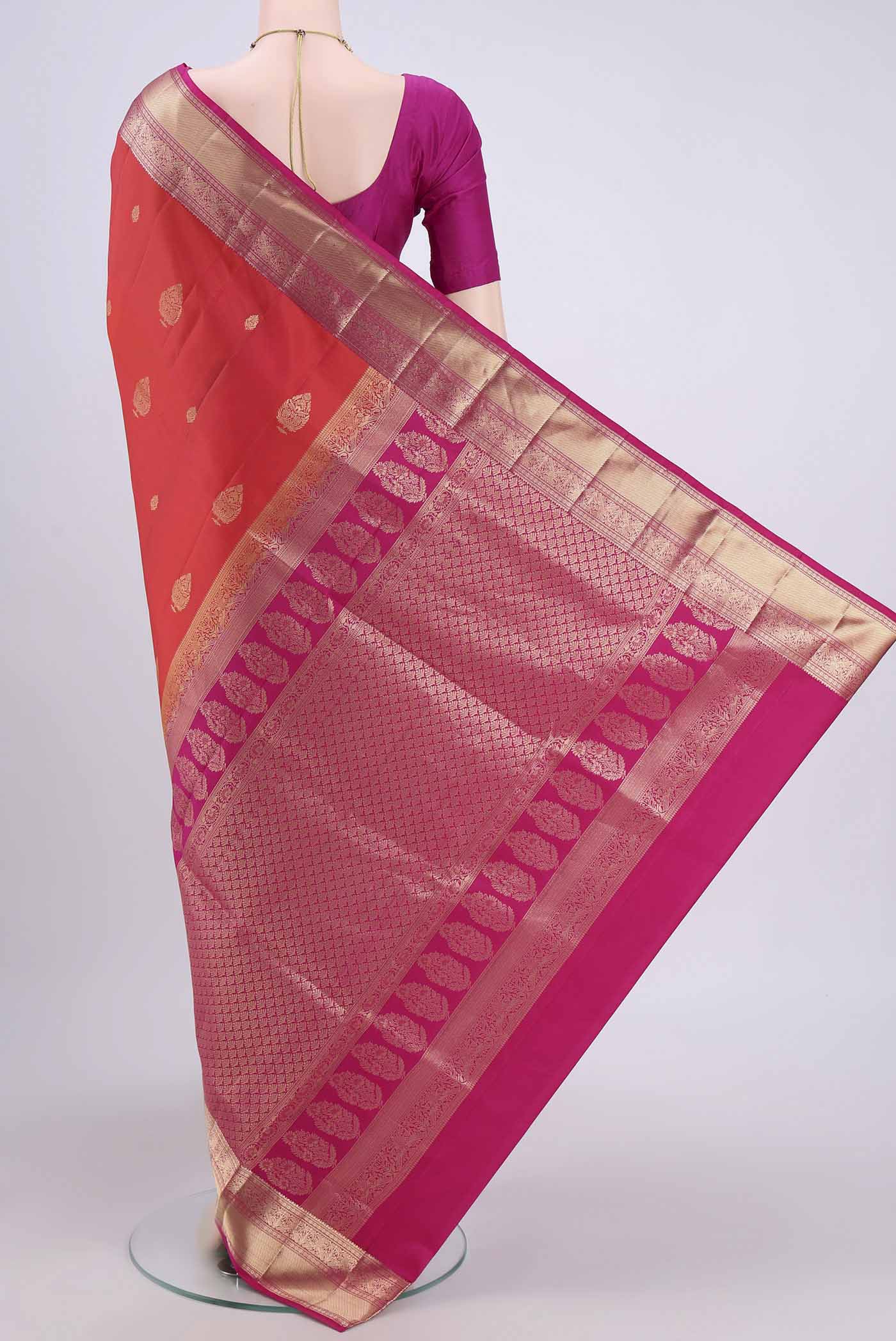 Flat view of Brick Orange Soft Silk Saree with Zari Butta on the body and Zari Border. 