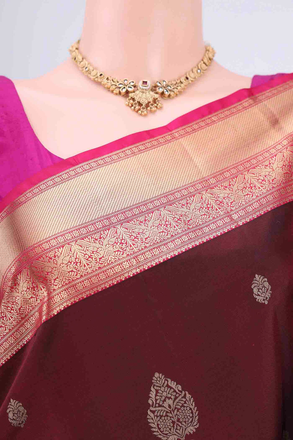 Border image of Maroon Soft Silk Saree with Zari Butta on the body and Zari Border. 