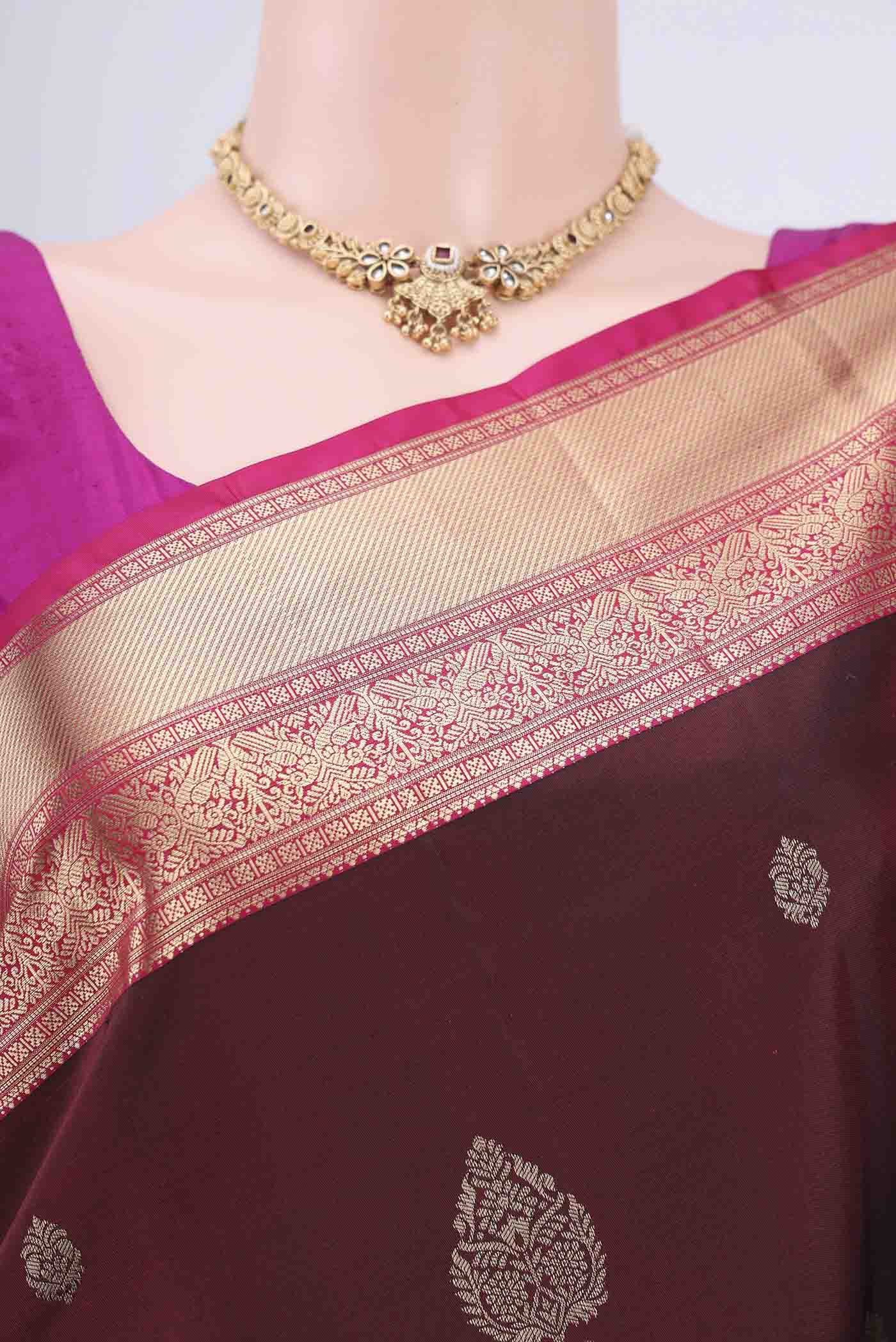 Border image of Maroon Soft Silk Saree with Zari Butta on the body and Zari Border. 