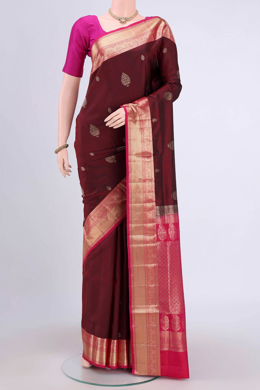 Maroon Soft Silk Saree with Zari Butta on the body and Zari Border.  displayed on a mannequin