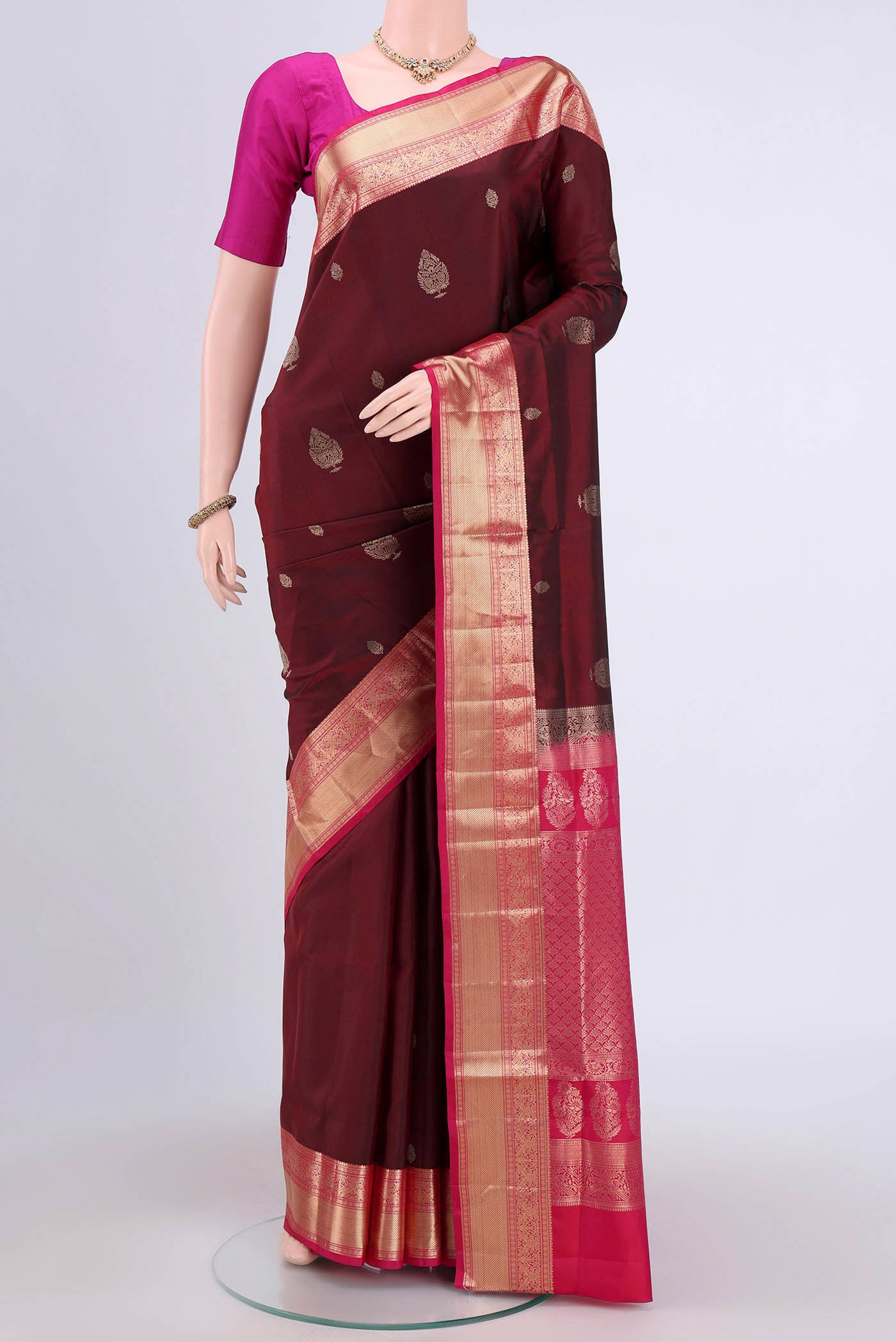 Maroon Soft Silk Saree with Zari Butta on the body and Zari Border.  displayed on a mannequin