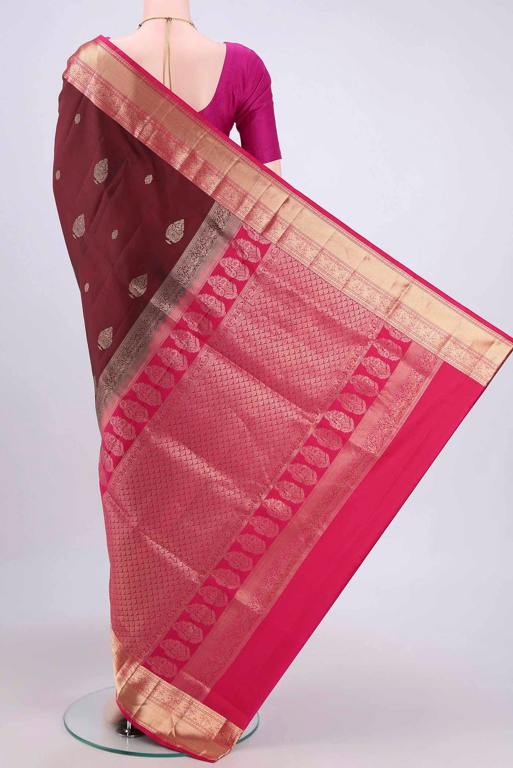 Flat view of Maroon Soft Silk Saree with Zari Butta on the body and Zari Border. 