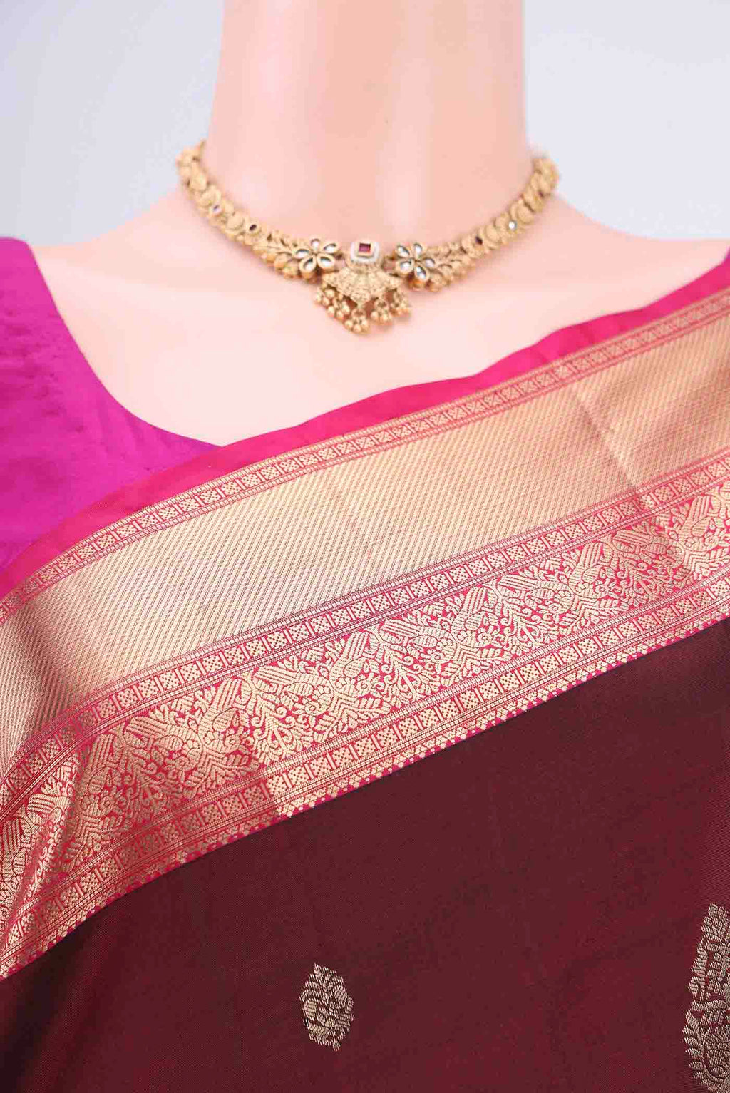 Border image of Maroon Soft Silk Saree with Zari Butta on the body and Zari Border. 