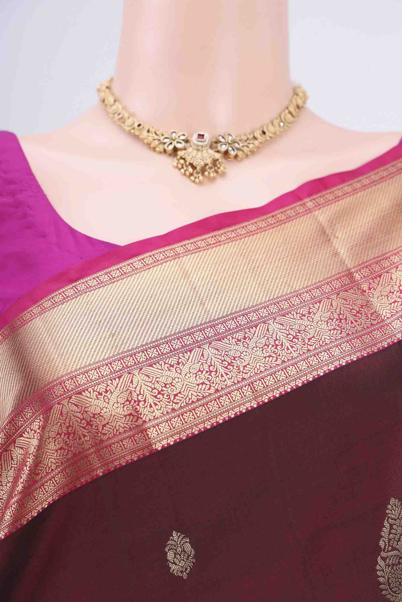 Border image of Maroon Soft Silk Saree with Zari Butta on the body and Zari Border. 