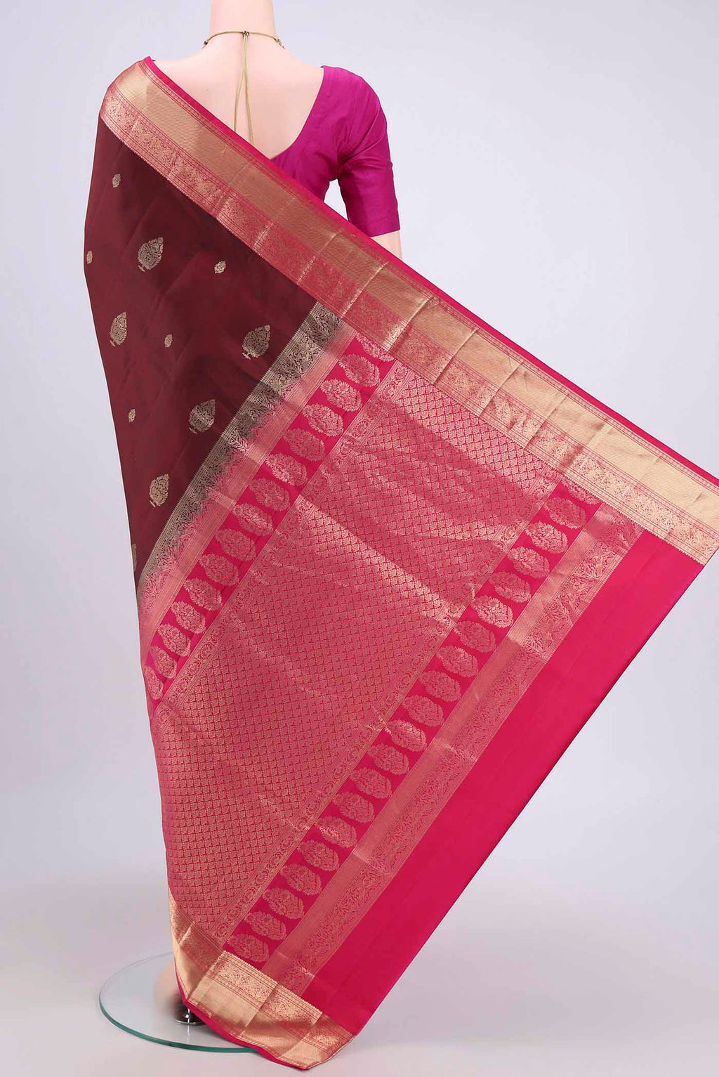 Flat view of Maroon Soft Silk Saree with Zari Butta on the body and Zari Border. 