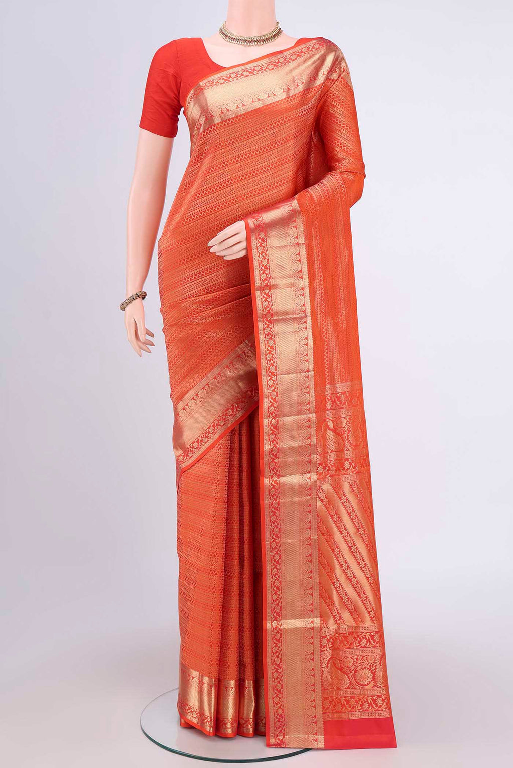 Brick Orange Dual Tone Soft Silk Saree with Zari Brocade on the body and Zari Border.  displayed on a mannequin