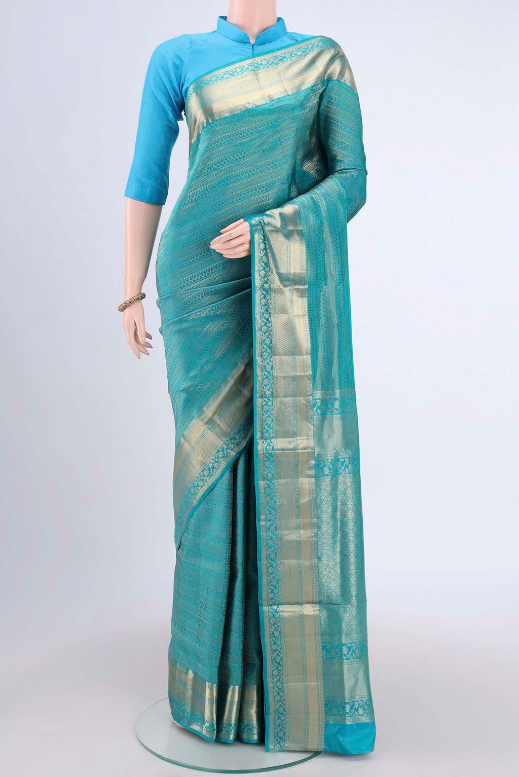 Sea Green Soft Silk Saree with Zari Brocade on the body and Zari Border.  displayed on a mannequin