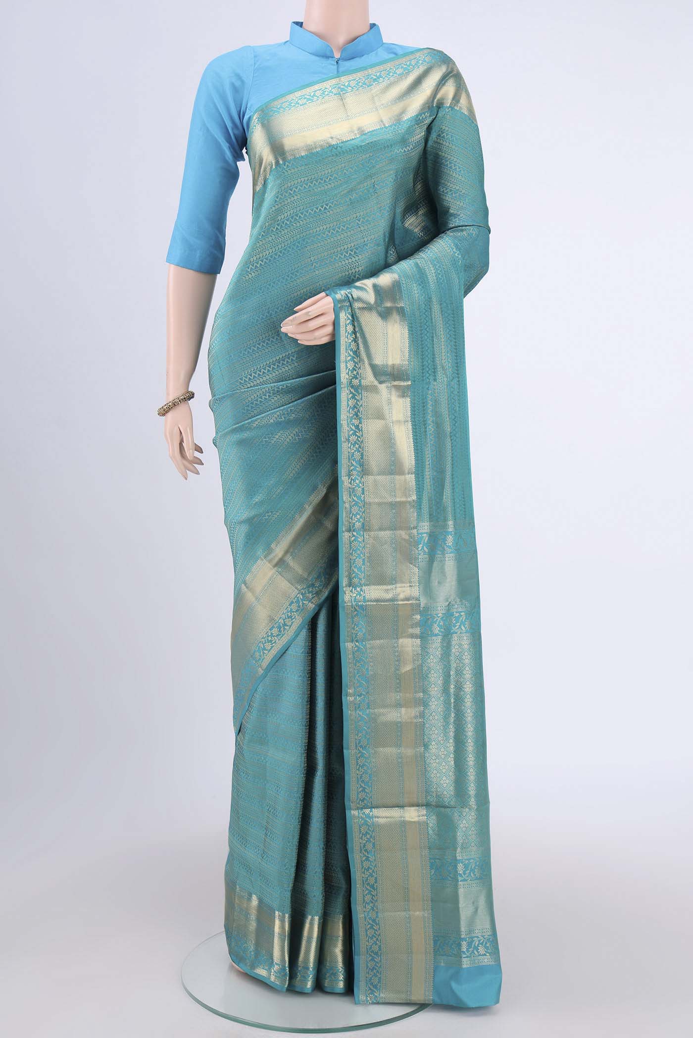 Sea Green Soft Silk Saree with Zari Brocade on the body and Zari Border.  displayed on a mannequin