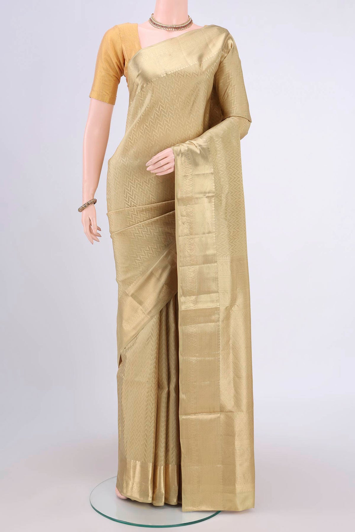 Dark Beige Soft Silk Saree with Zig Zag design on the body and Zari Border.  displayed on a mannequin