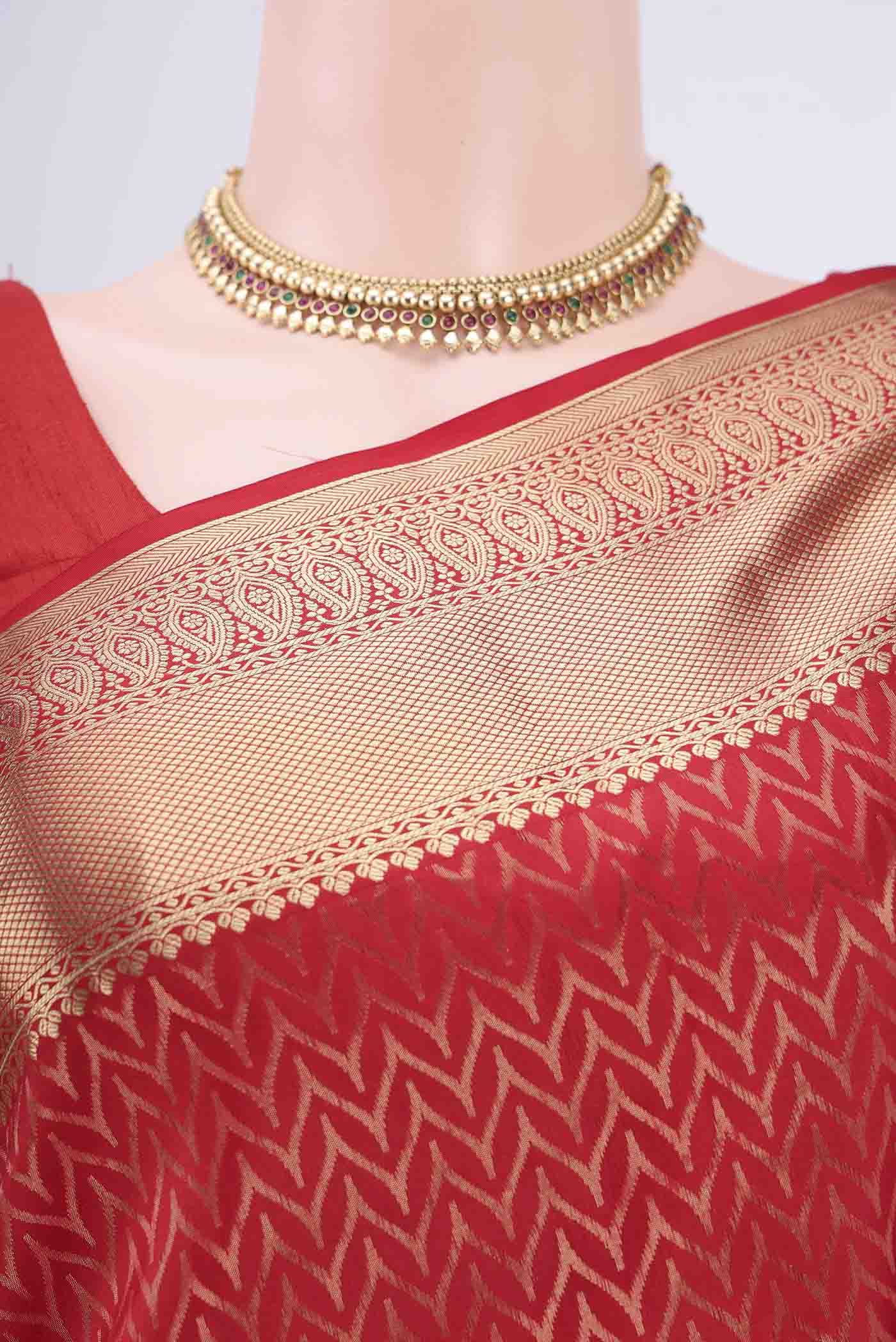 Border image of Red Soft Silk Saree with Zig Zag design on the body and Zari Border. 