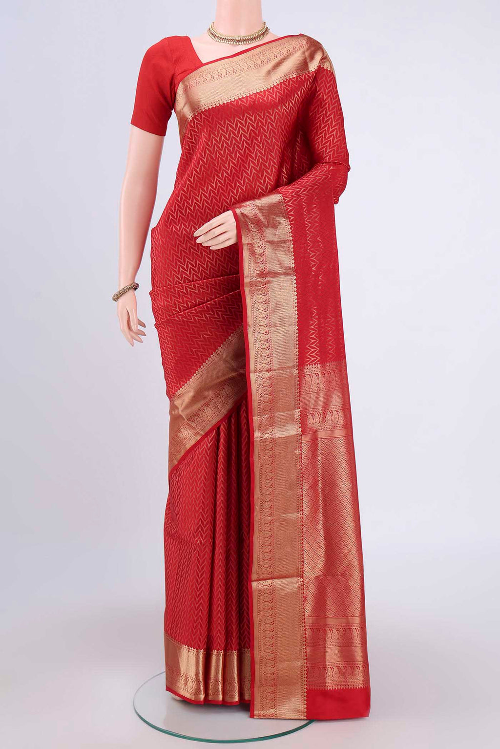 Red Soft Silk Saree with Zig Zag design on the body and Zari Border.  displayed on a mannequin