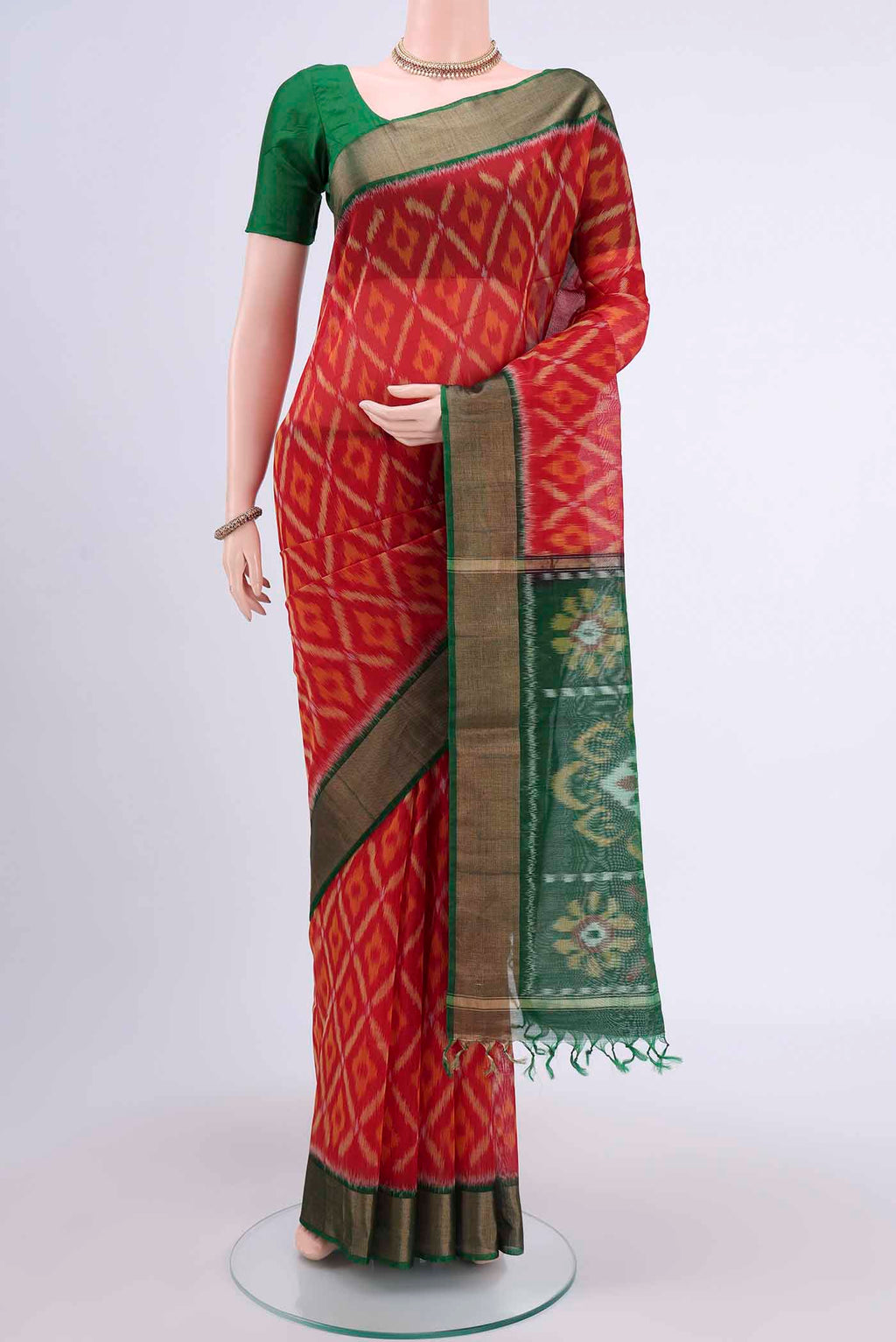 Red Kora Cotton Saree with Ikat design on the body and Zari Border displayed on a mannequin