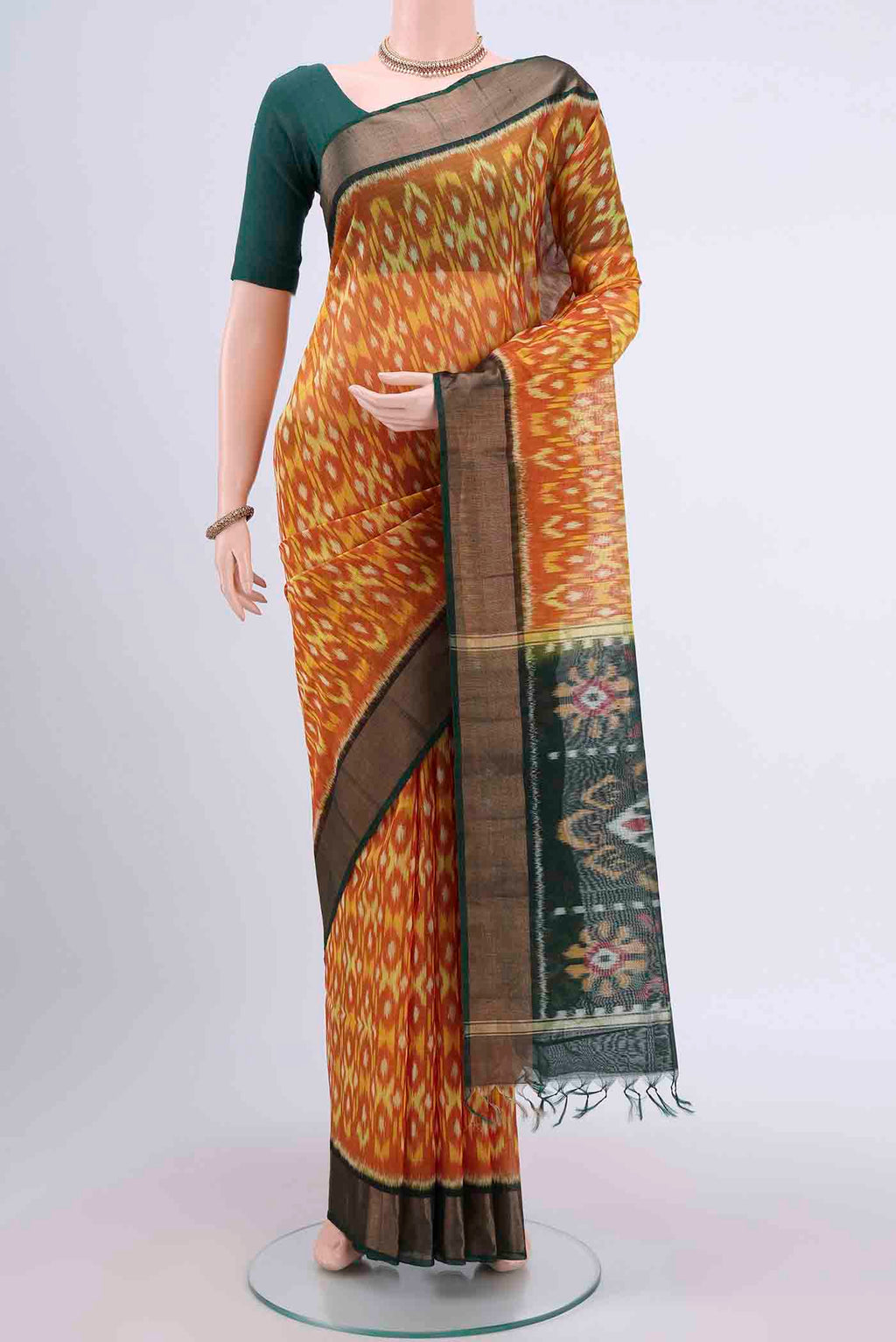 Brick Orange Kora Cotton Saree with Ikat design on the body and Zari Border displayed on a mannequin