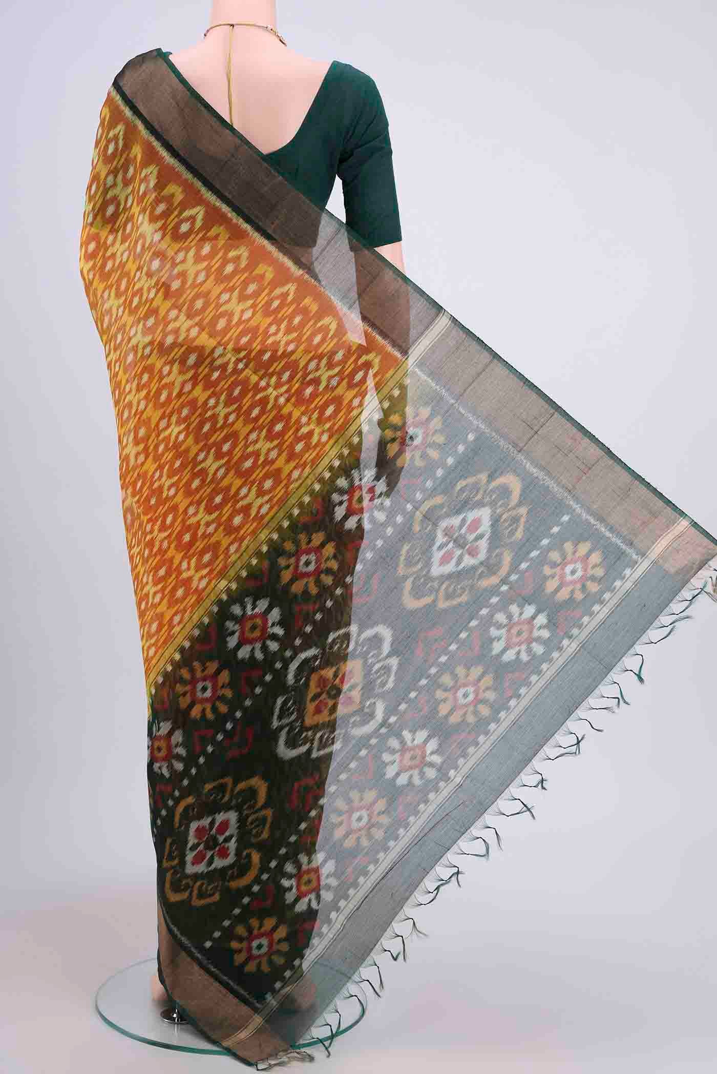 Flat view of Brick Orange Kora Cotton Saree with Ikat design on the body and Zari Border