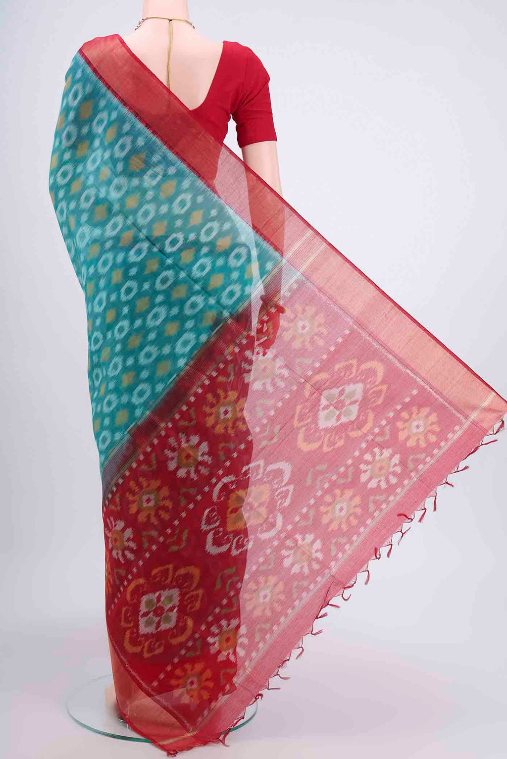 Flat view of Sea Green Kora Cotton Saree with Ikat design on the body and Zari Border