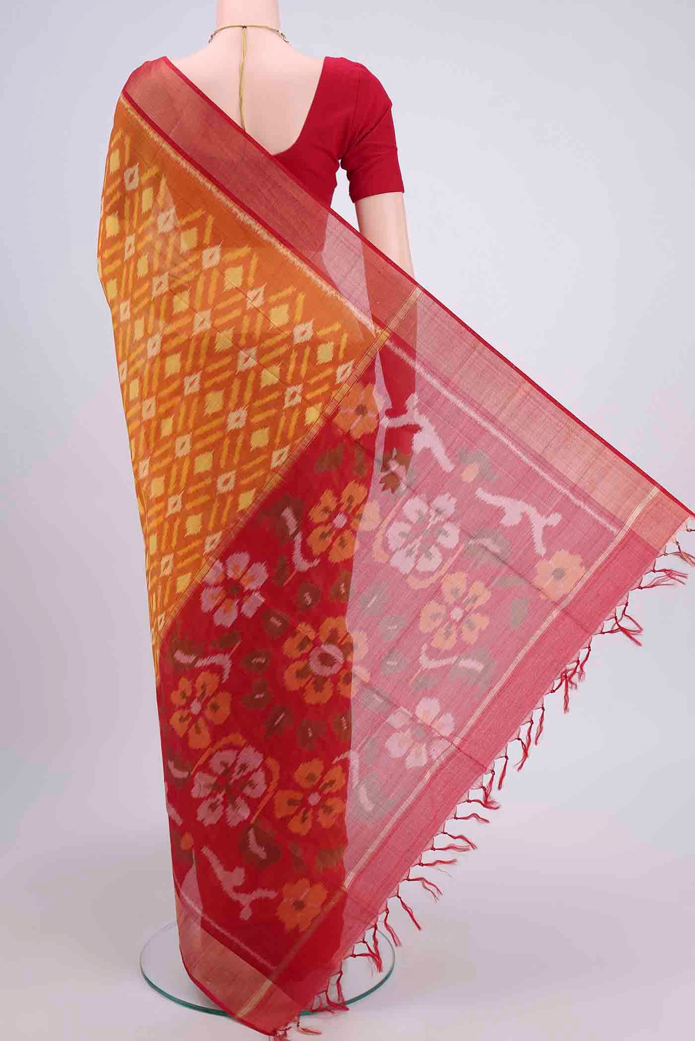 Flat view of Brick Orange Kora Cotton Saree with Ikat design on the body and Zari Border