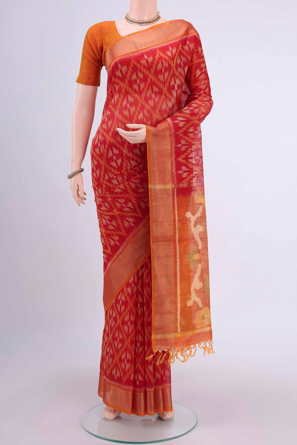 Red Pochampally Saree with Ikat design on the body and Zari Border displayed on a mannequin