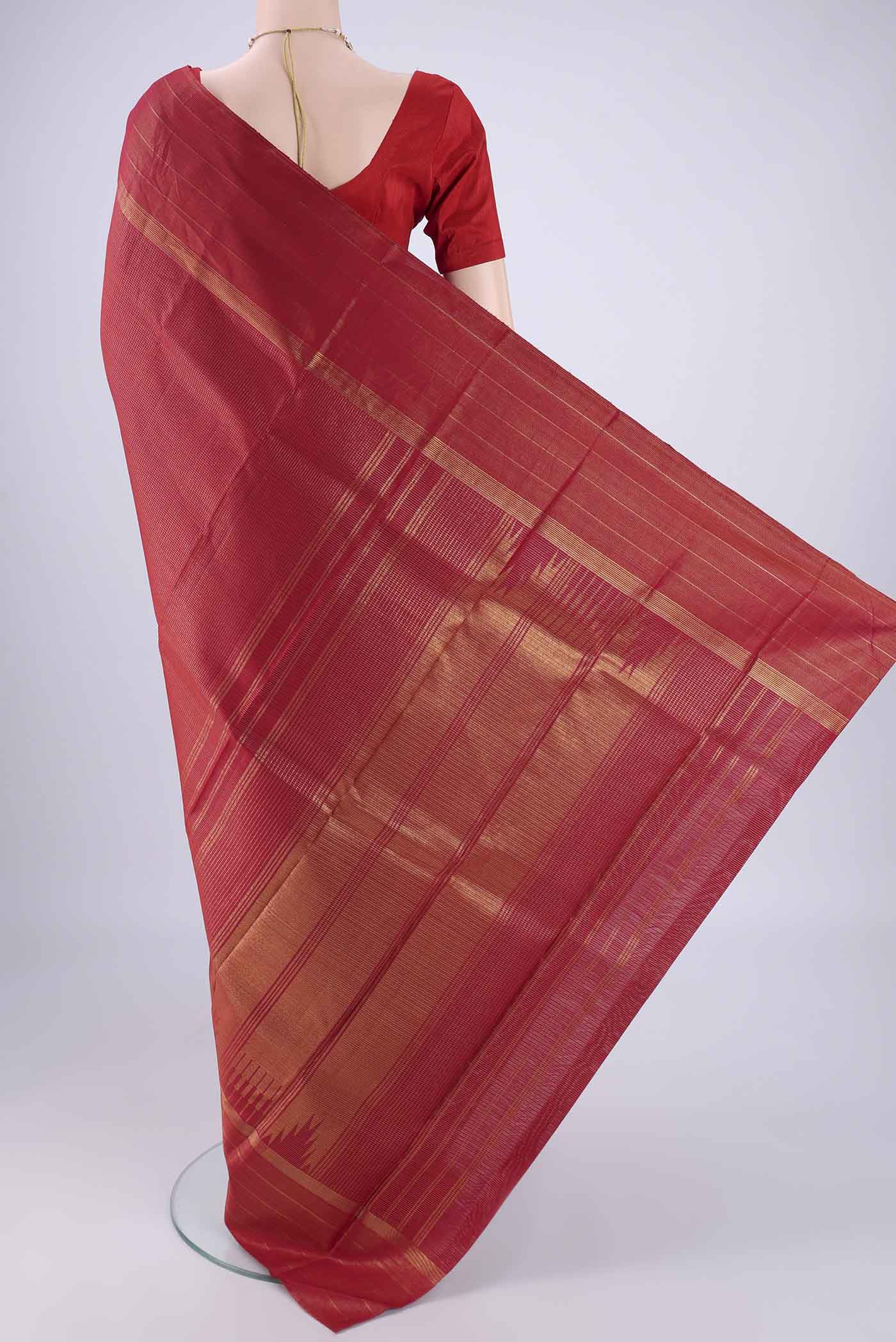 Flat view of Maroon Kanchipuram Silk Saree with Checked design on the body and Zari Border. 