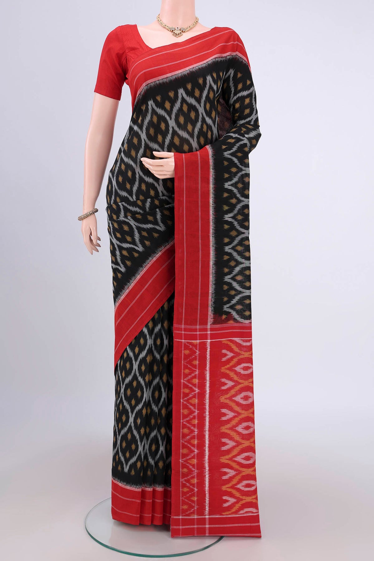 Black Pochampally Cotton Saree with Ikat design on the body and Ikat Border.  displayed on a mannequin
