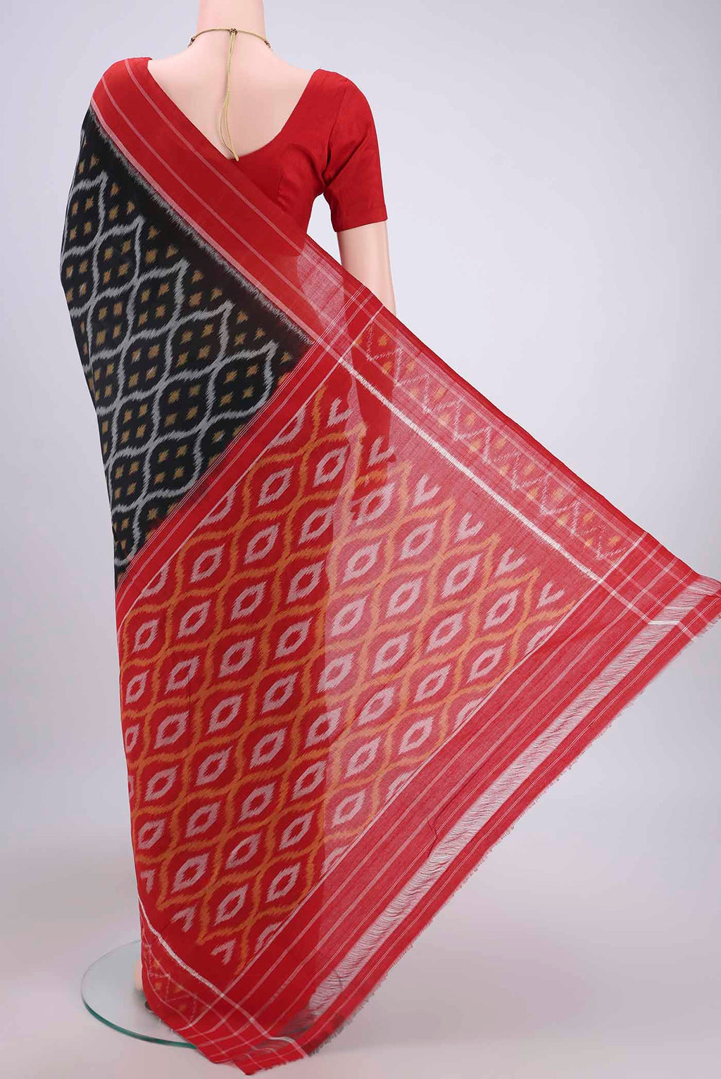 Flat view of Black Pochampally Cotton Saree with Ikat design on the body and Ikat Border. 