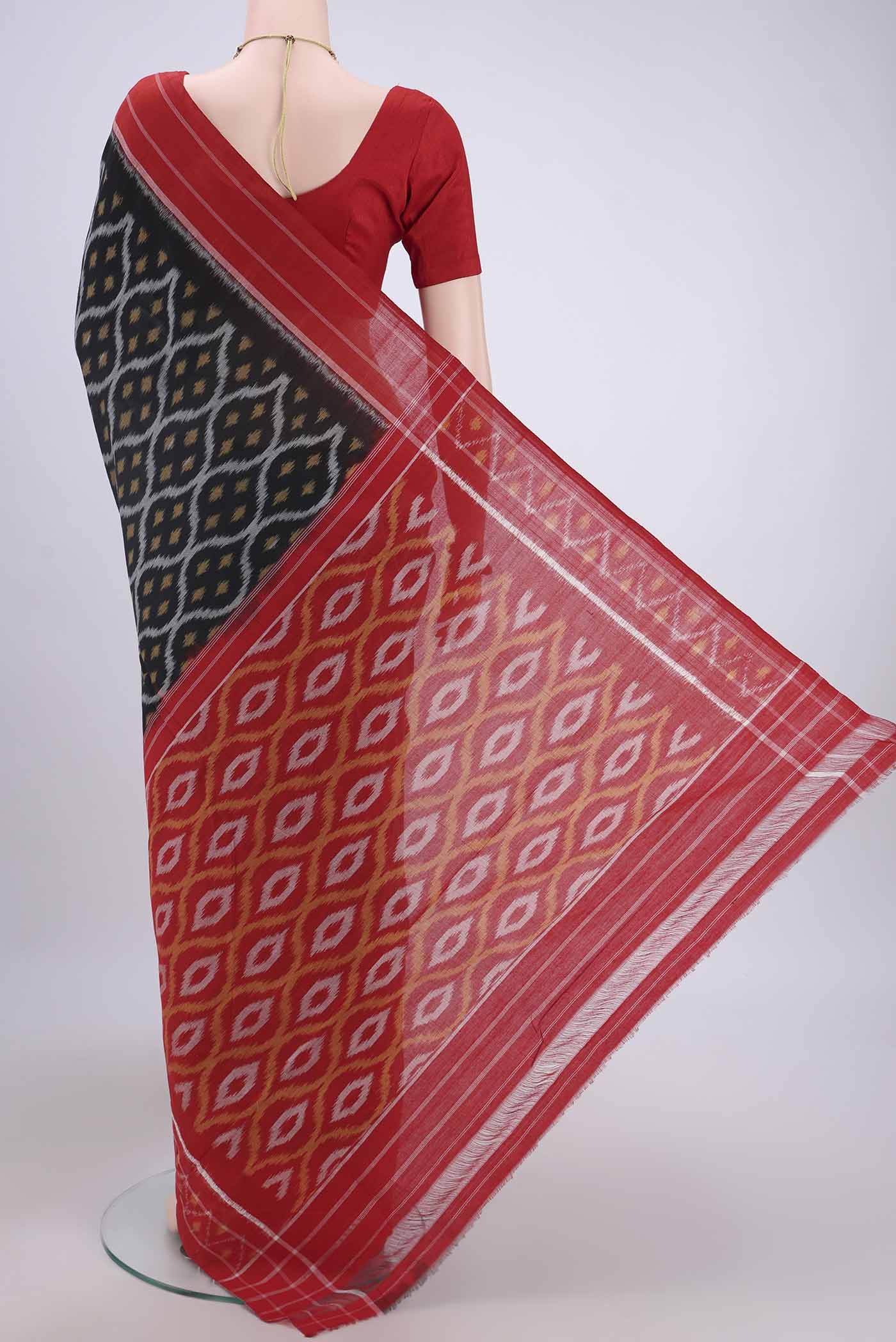 Flat view of Black Pochampally Cotton Saree with Ikat design on the body and Ikat Border. 
