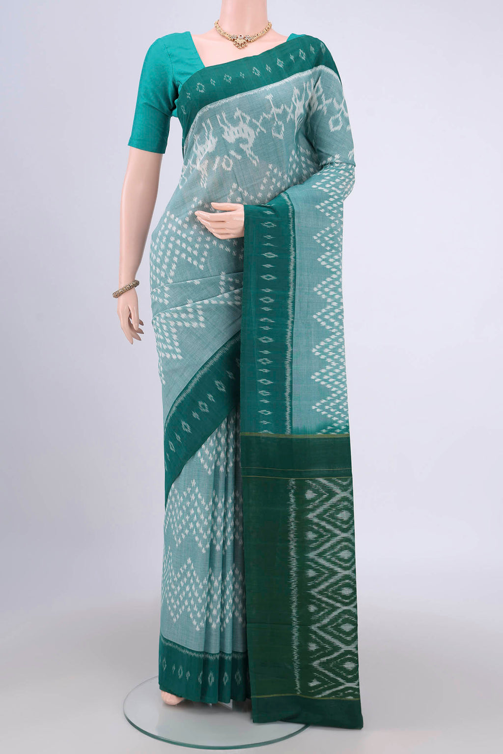 Sea Green Pochampally Cotton Saree with Ikat design on the body and Ikat Border.  displayed on a mannequin