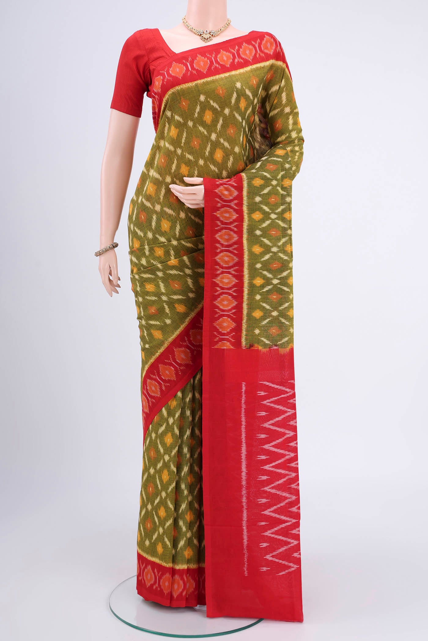 Mehandi Green Pochampally Cotton Saree with Ikat design on the body and Ikat Border.  displayed on a mannequin