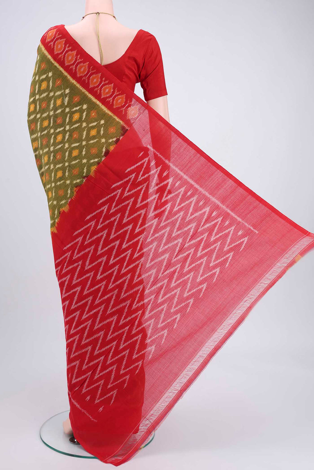 Flat view of Mehandi Green Pochampally Cotton Saree with Ikat design on the body and Ikat Border. 
