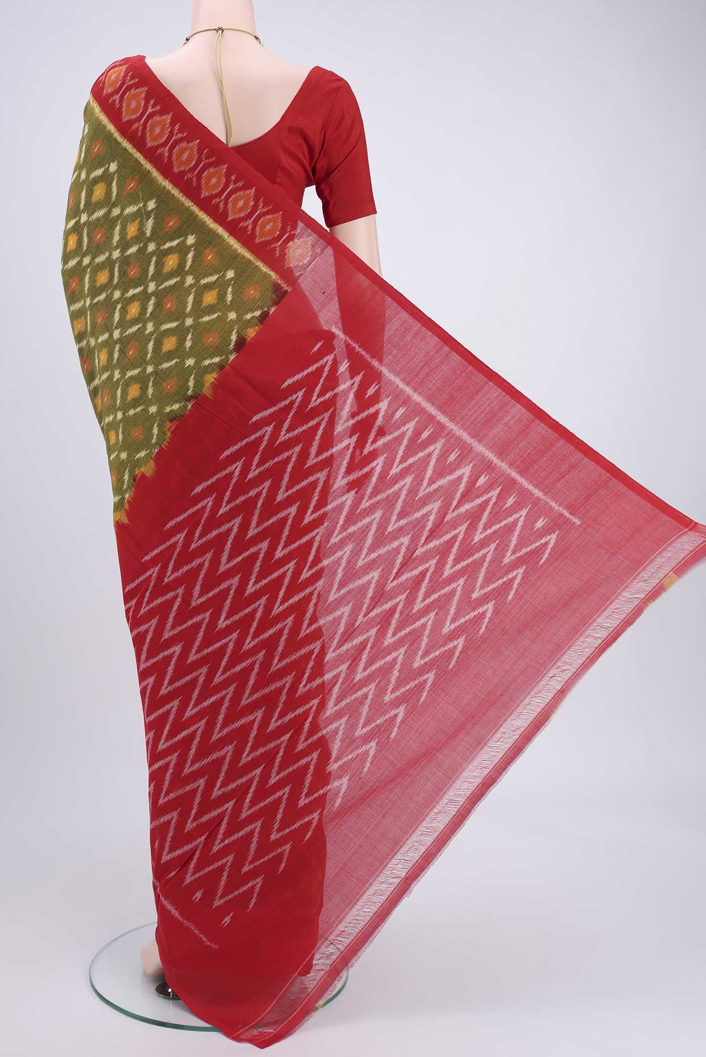 Flat view of Mehandi Green Pochampally Cotton Saree with Ikat design on the body and Ikat Border. 