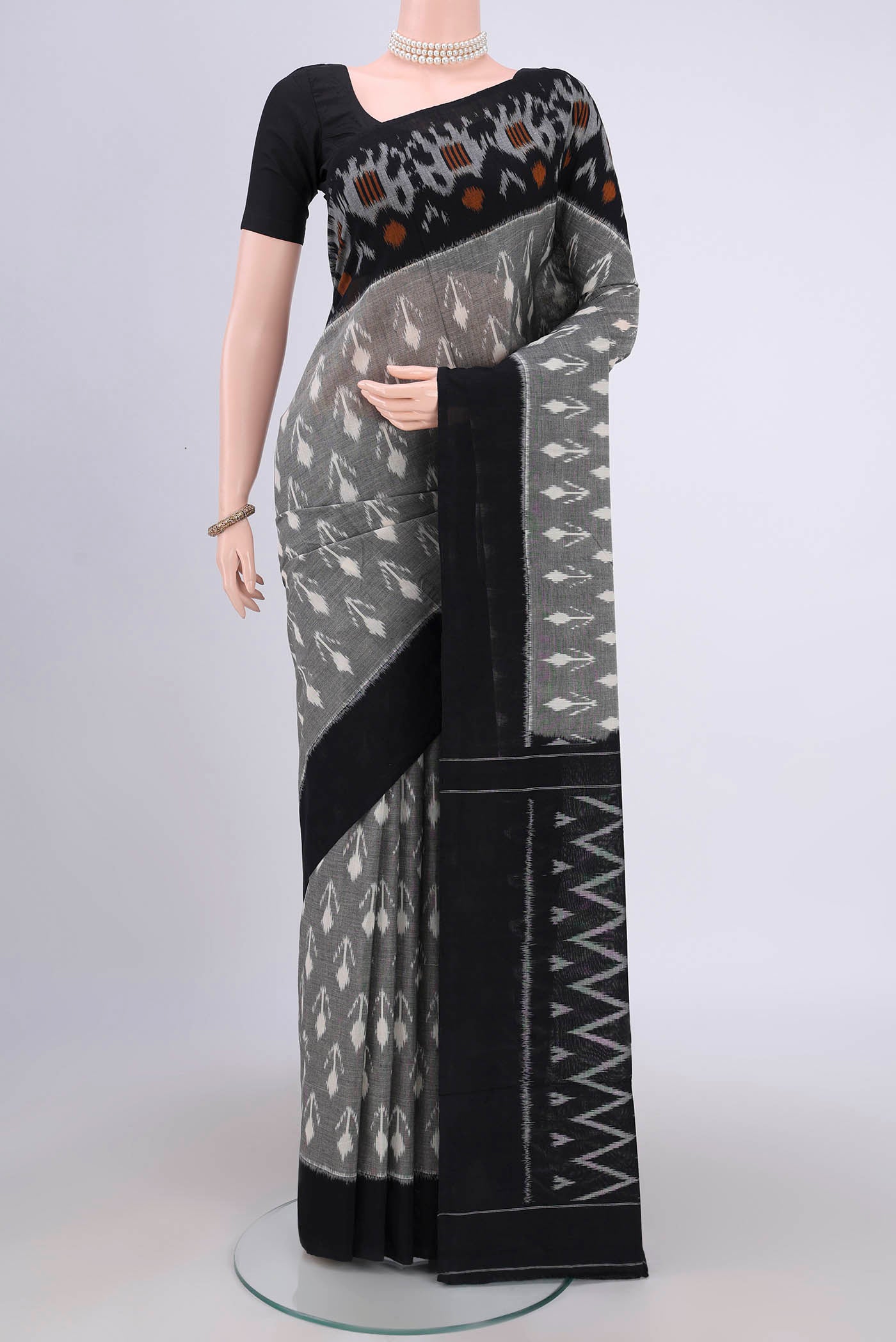 Grey Pochampally Cotton Saree with Ikat design on the body and Ikat Border.  displayed on a mannequin