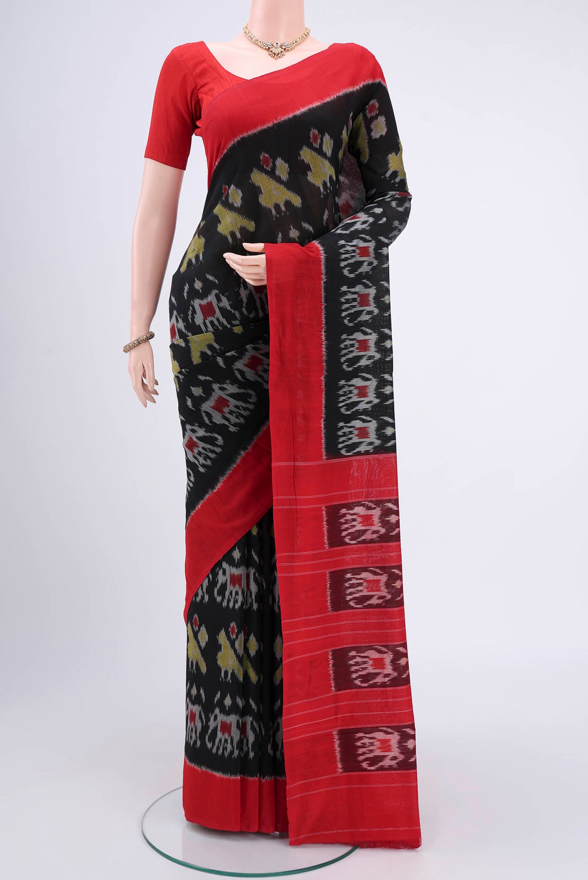 Black Pochampally Cotton Saree with Ikat design on the body and Ikat Border.  displayed on a mannequin