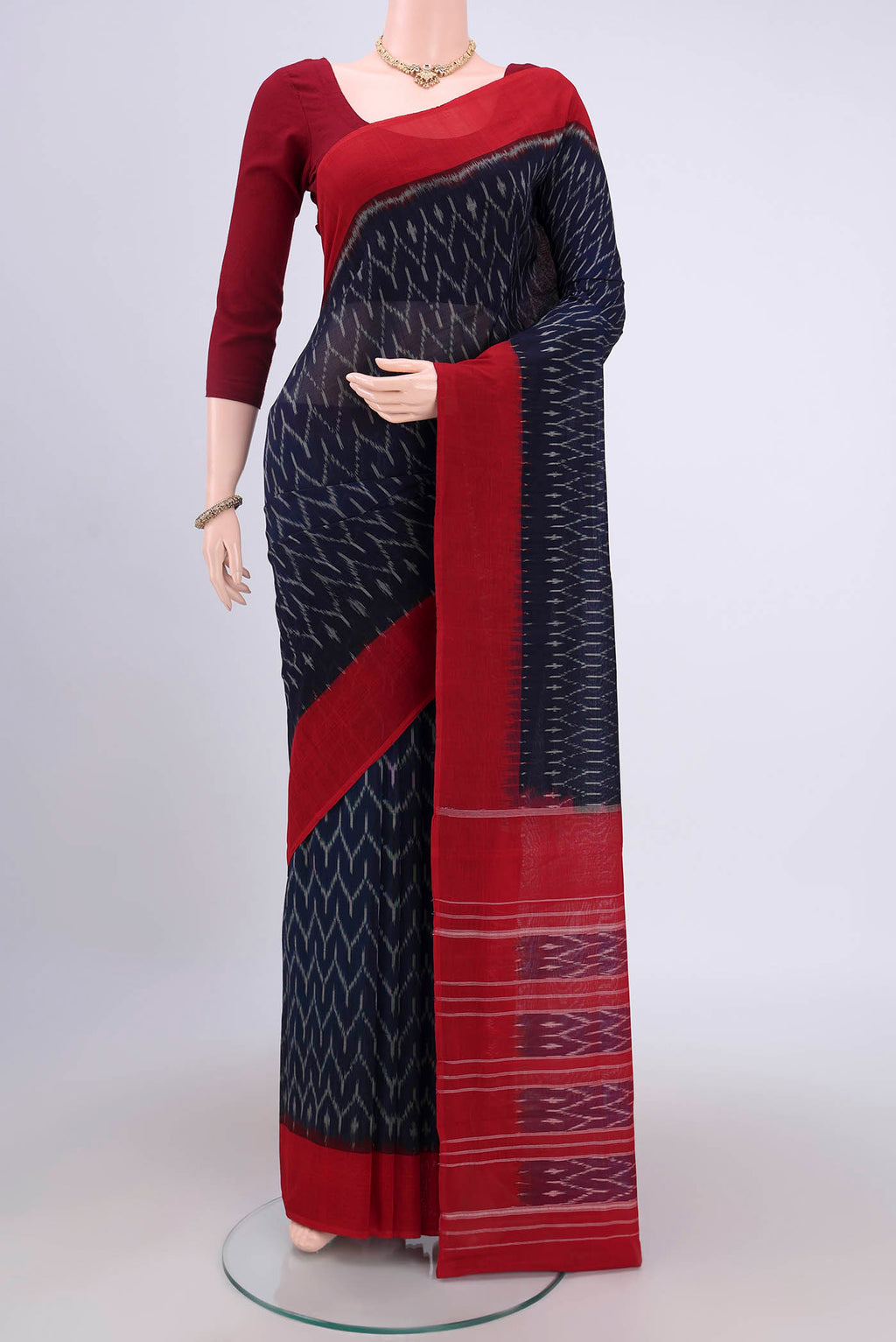 Navy Blue Pochampally Cotton Saree with Ikat design on the body and Ikat Border.  displayed on a mannequin