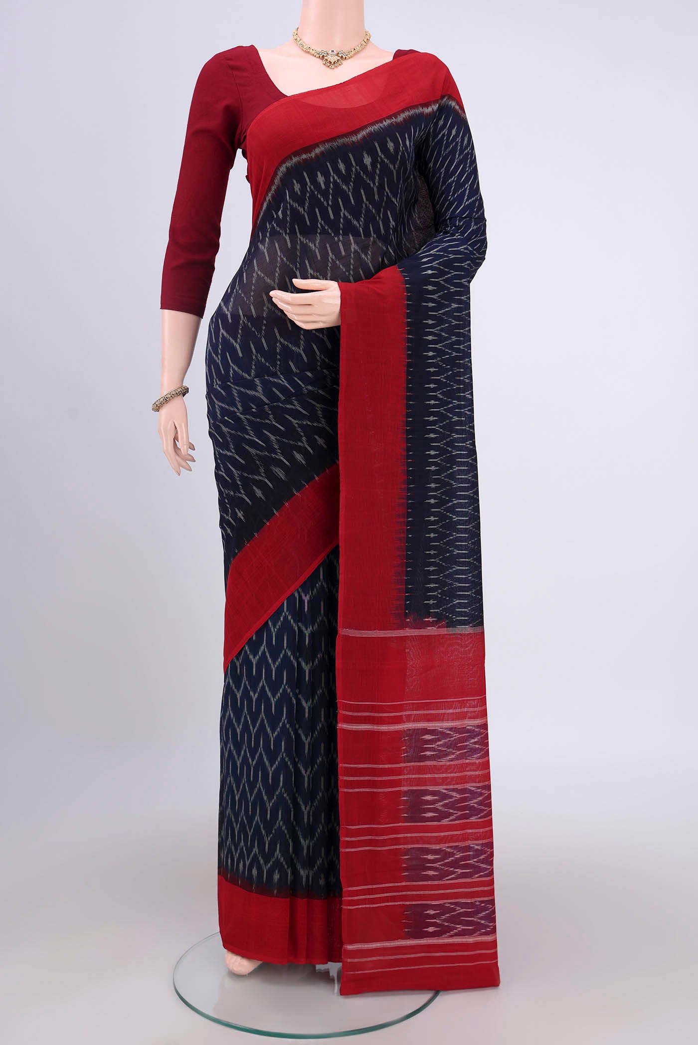 Navy Blue Pochampally Cotton Saree with Ikat design on the body and Ikat Border.  displayed on a mannequin