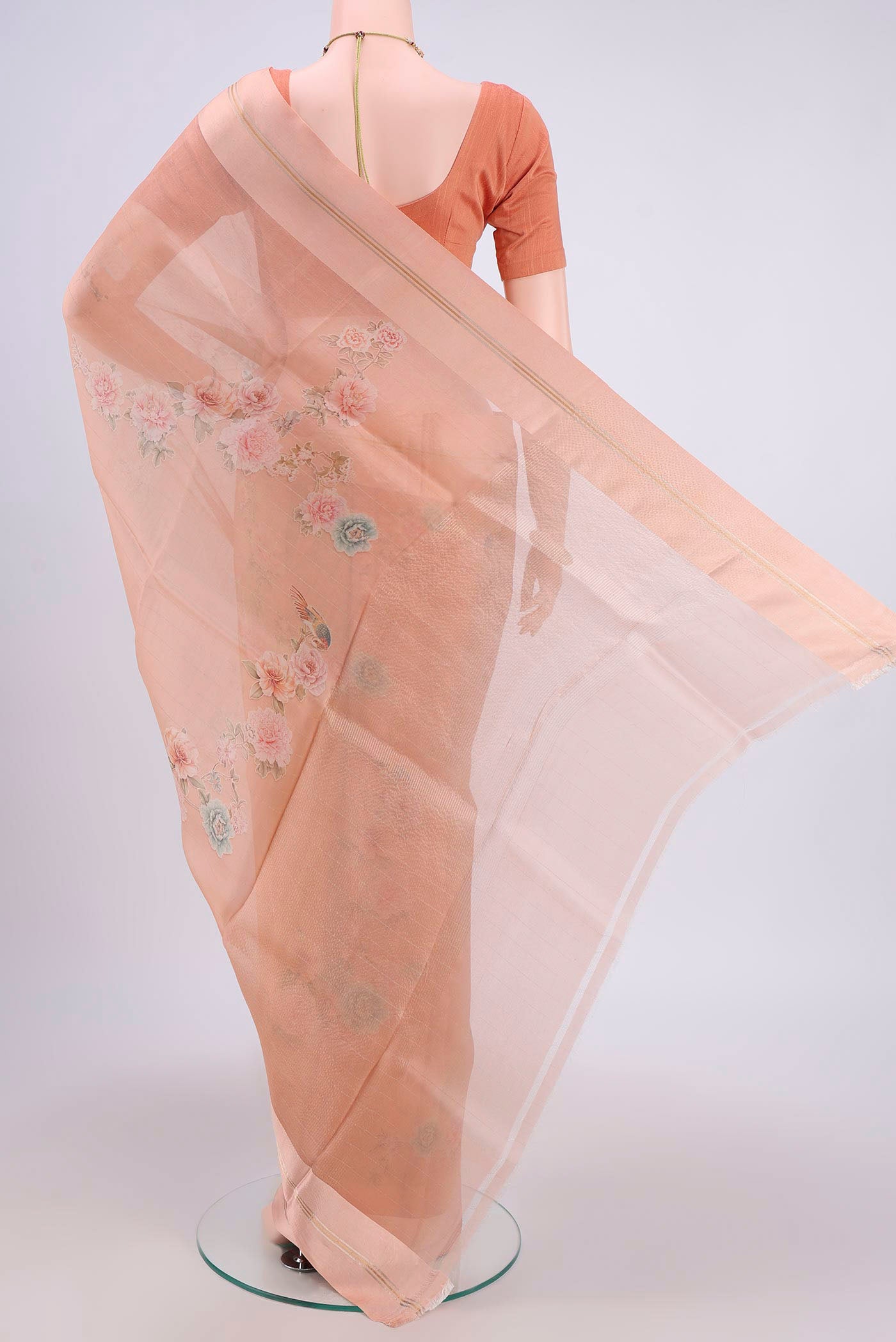 Flat view of Peach Organza Silk Saree with Printed design on the body and Satin Border. 