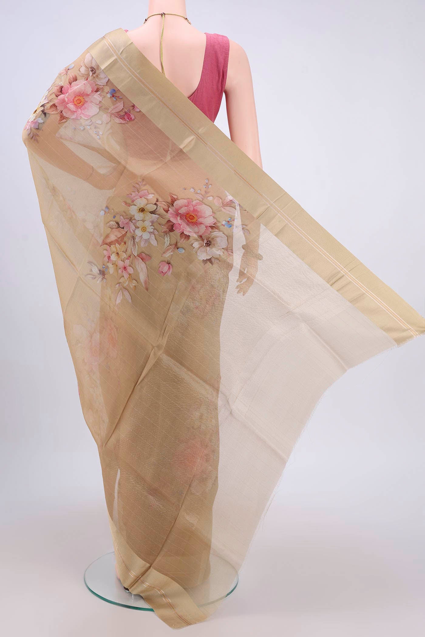 Flat view of Beige Organza Silk Saree with Printed design on the body and Satin Border. 